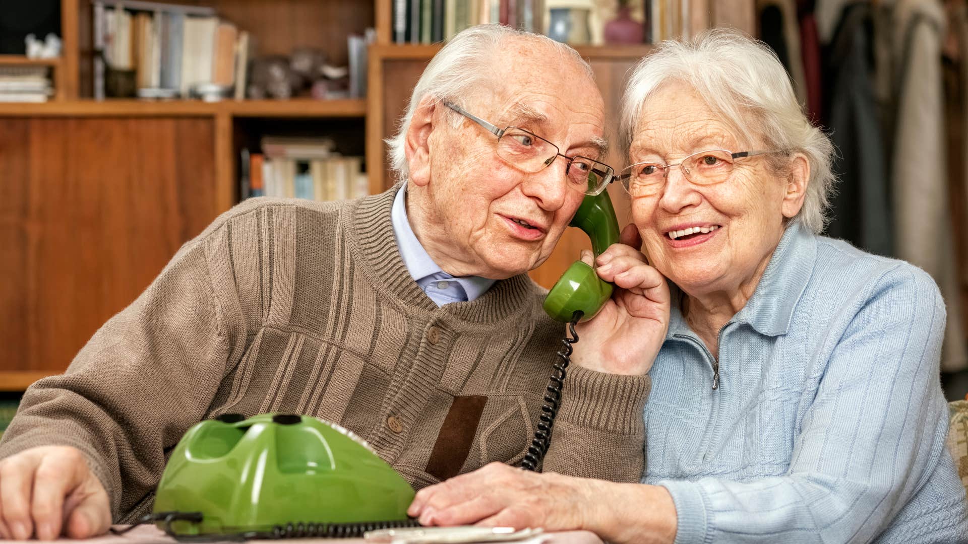 lonely parent talks on the landline phone in their house