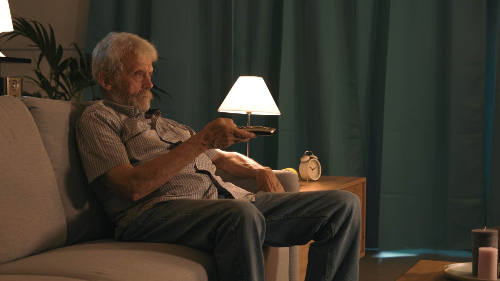 lonely father watches tv in his house