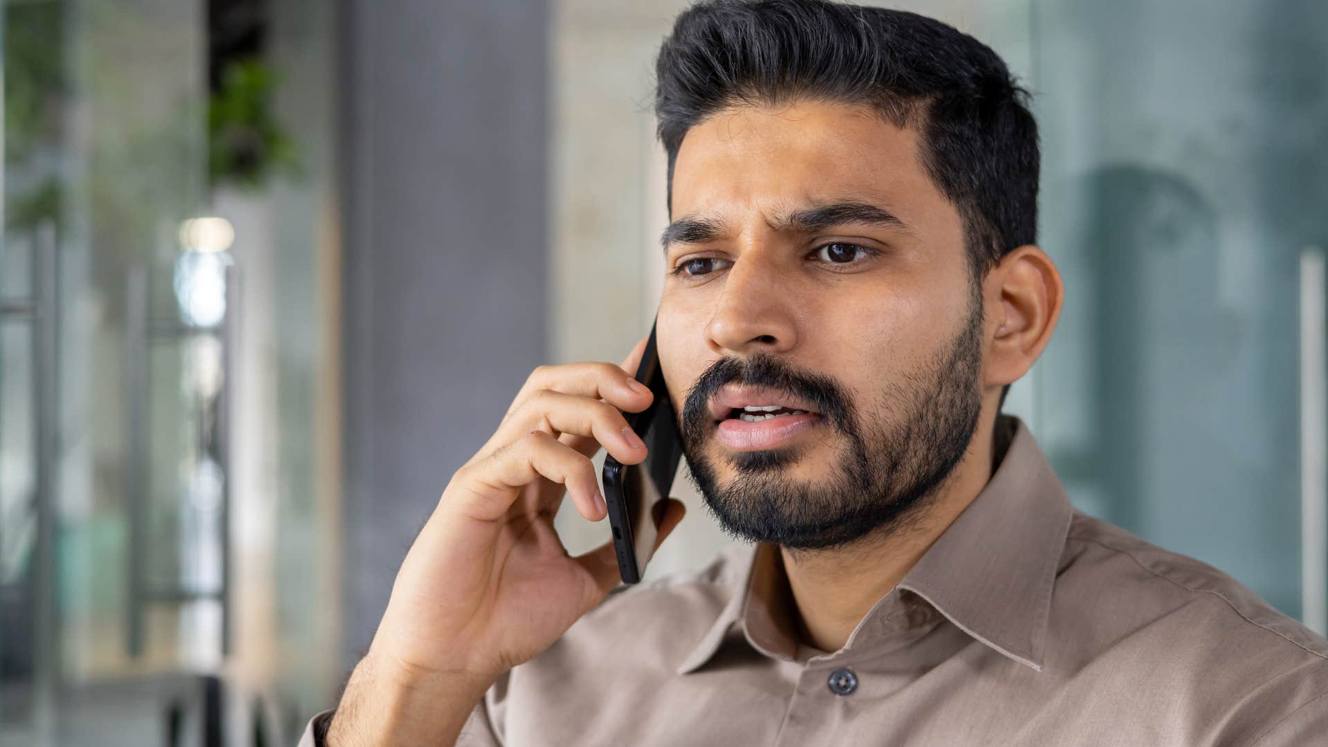 Man saying "parking is a nightmare here" on the phone.