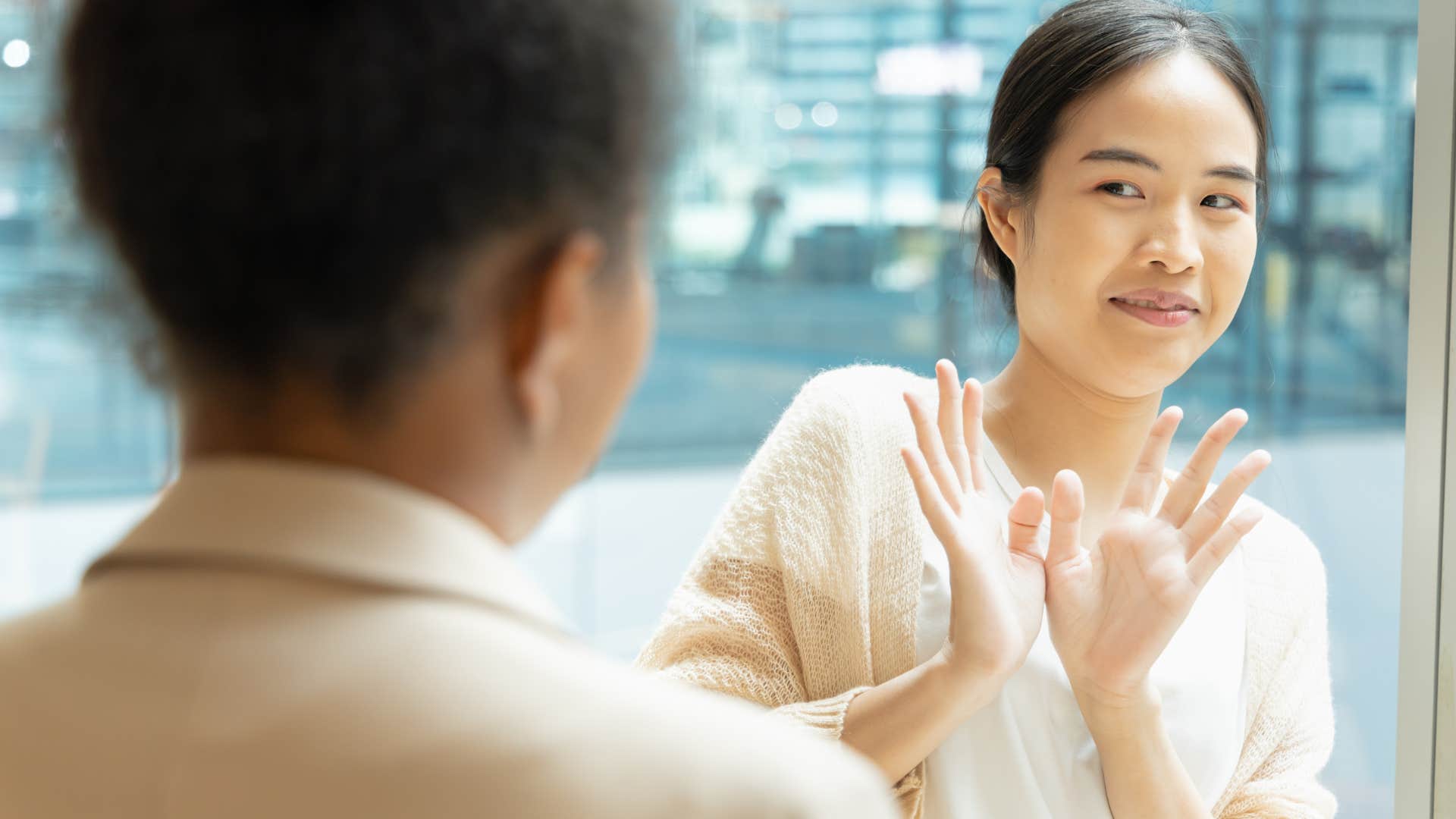 woman embarrassed by appearance saying ignore my face in a conversation