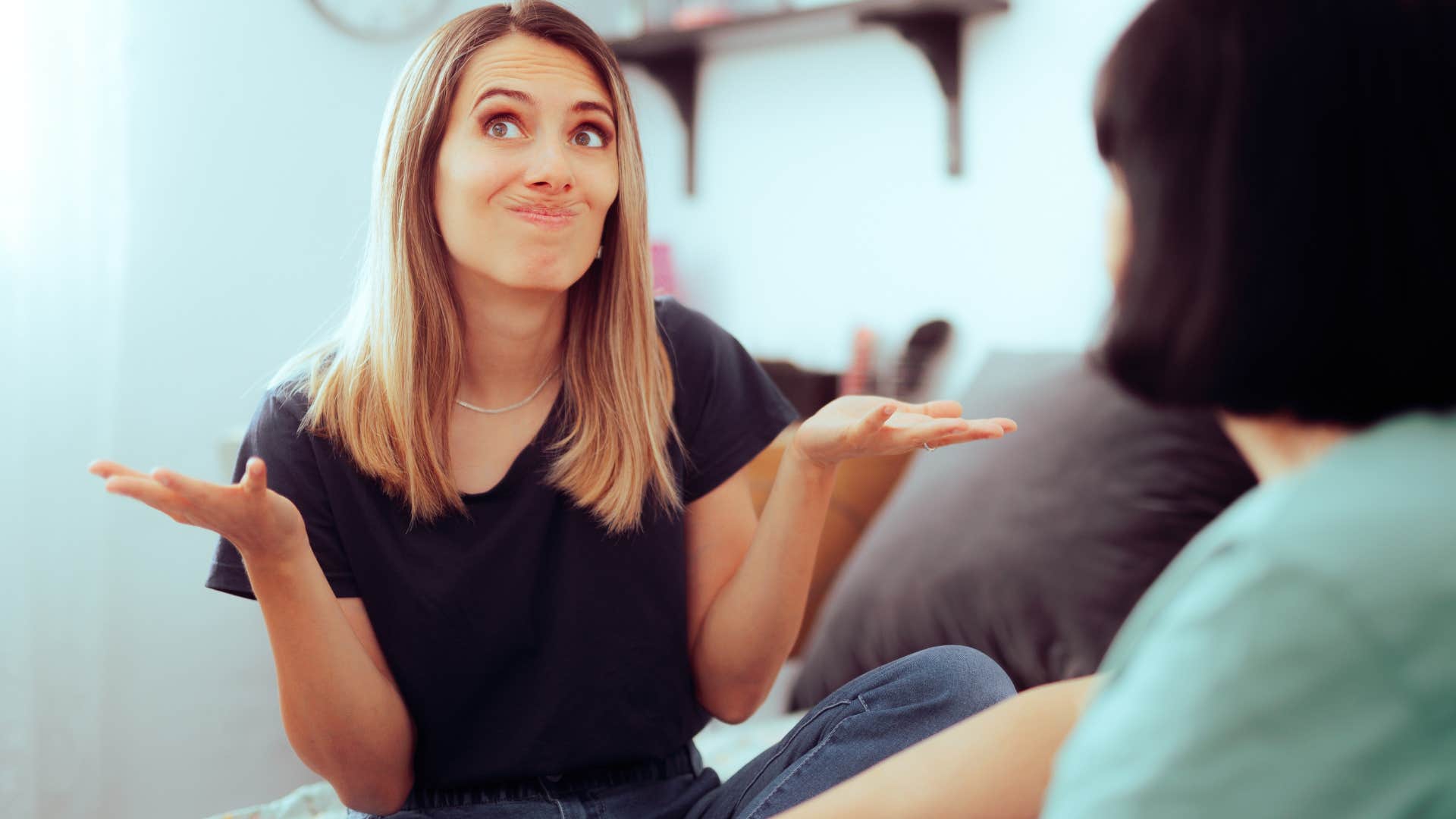 woman shrugging saying I normally don't look like this to a friend