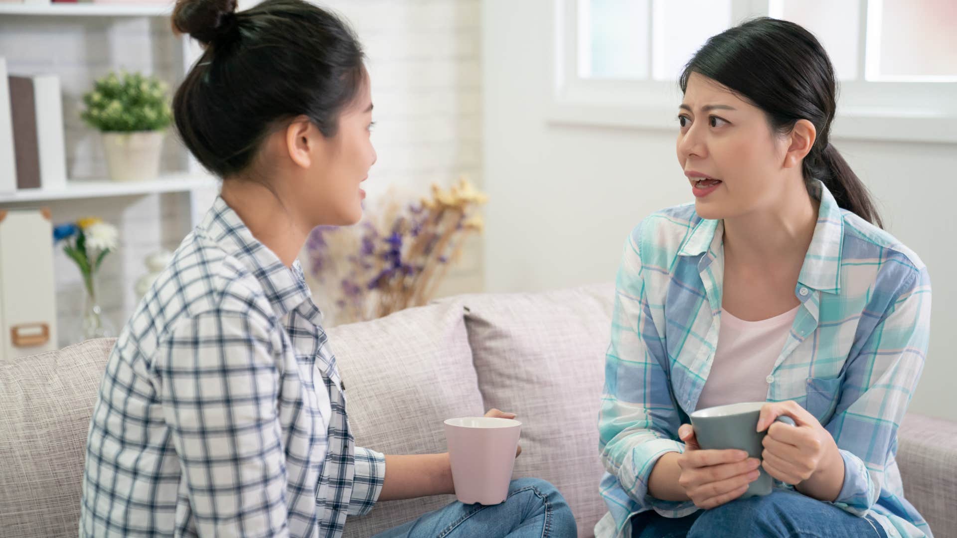 Woman saying "I wasn't expecting company" to her friend.