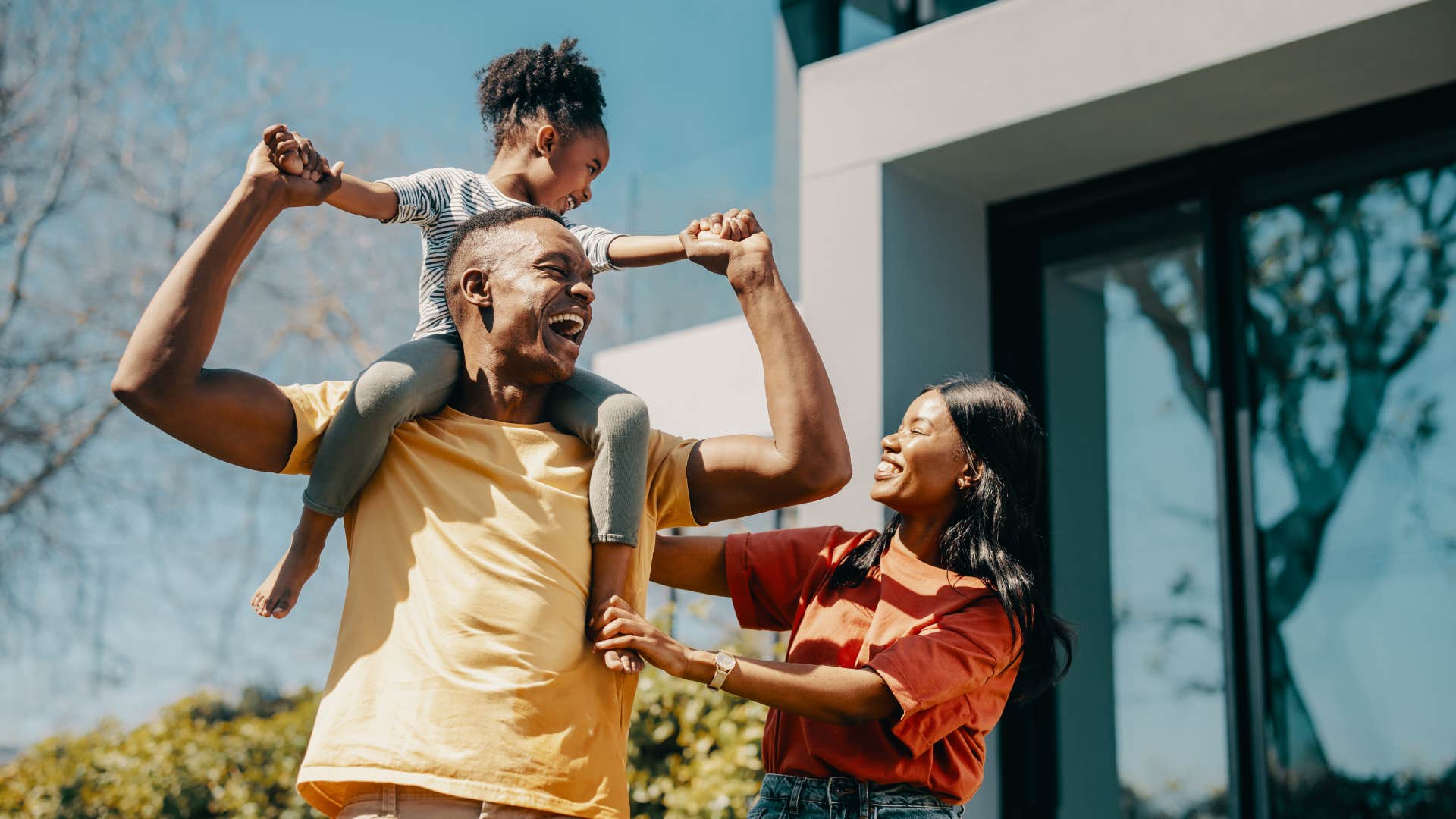 young family standing outside