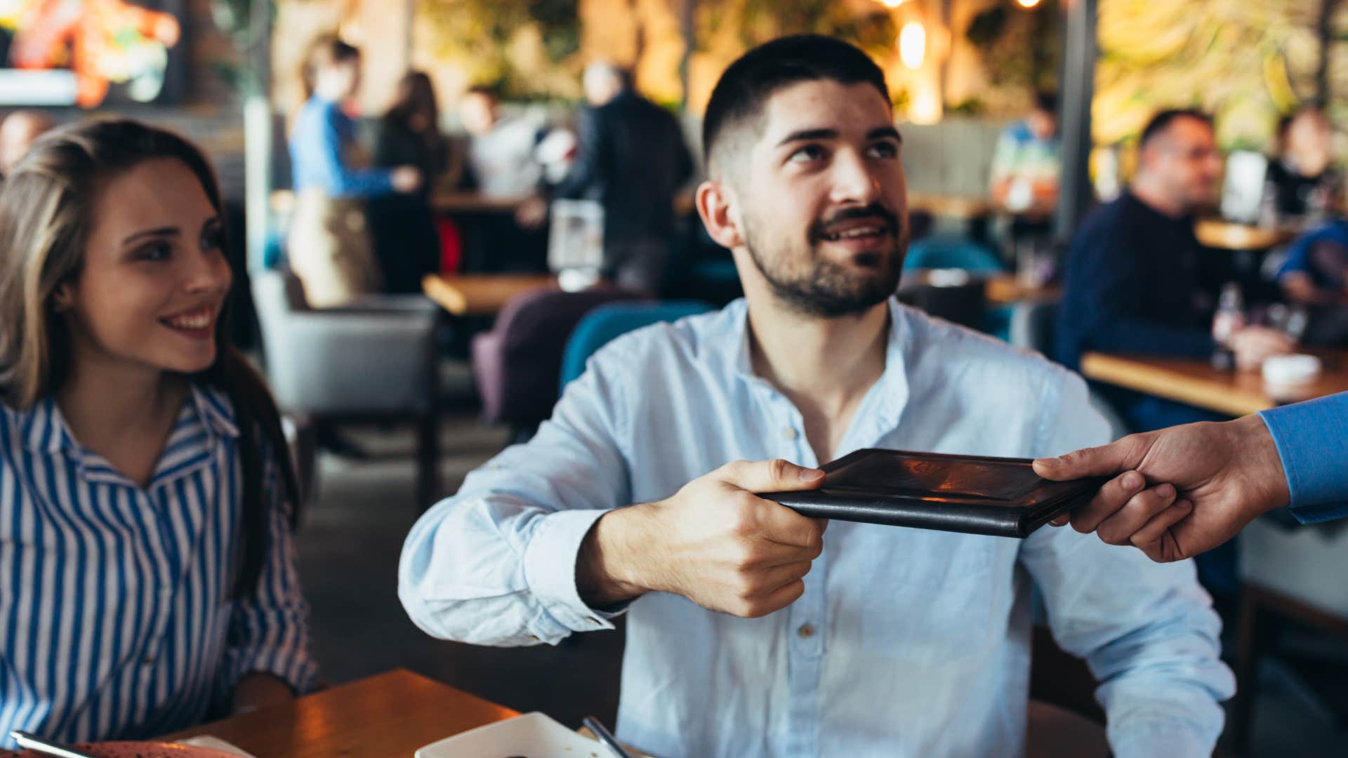 man paying bill at restaurant