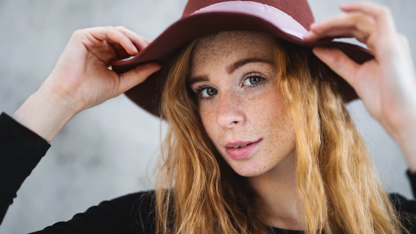 If A Woman Uses These Phrases, She's A Deeply Judgmental Person judgmental woman fixing her hat and staring