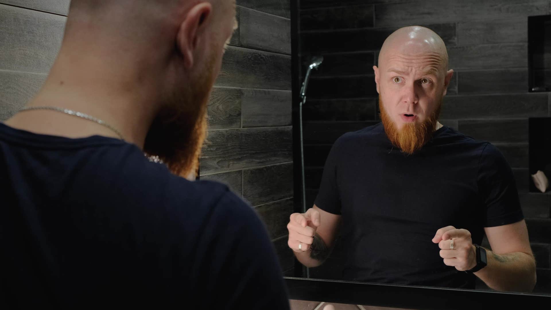 man talking to himself in the mirror