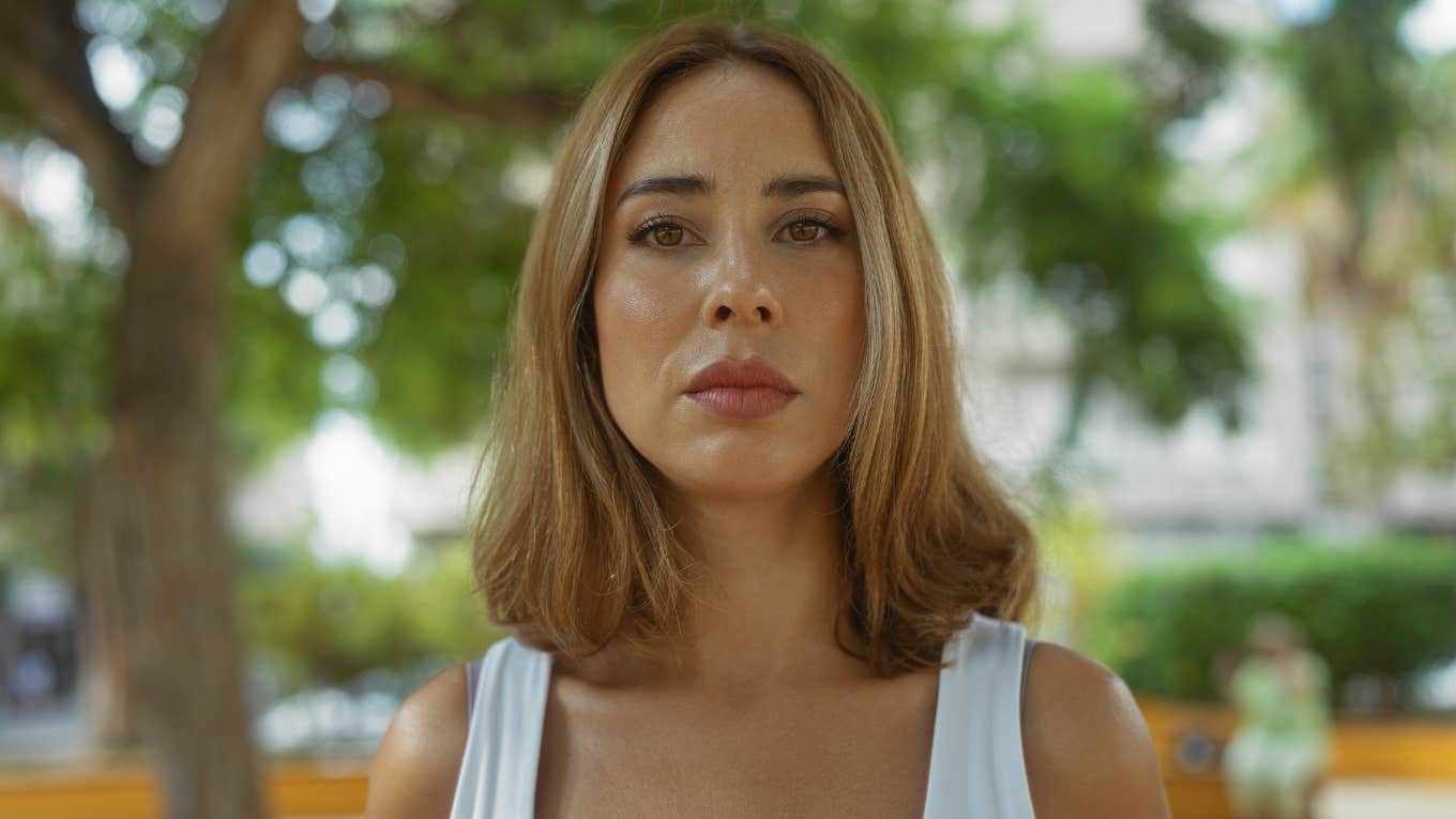 Serious woman looks at camera.