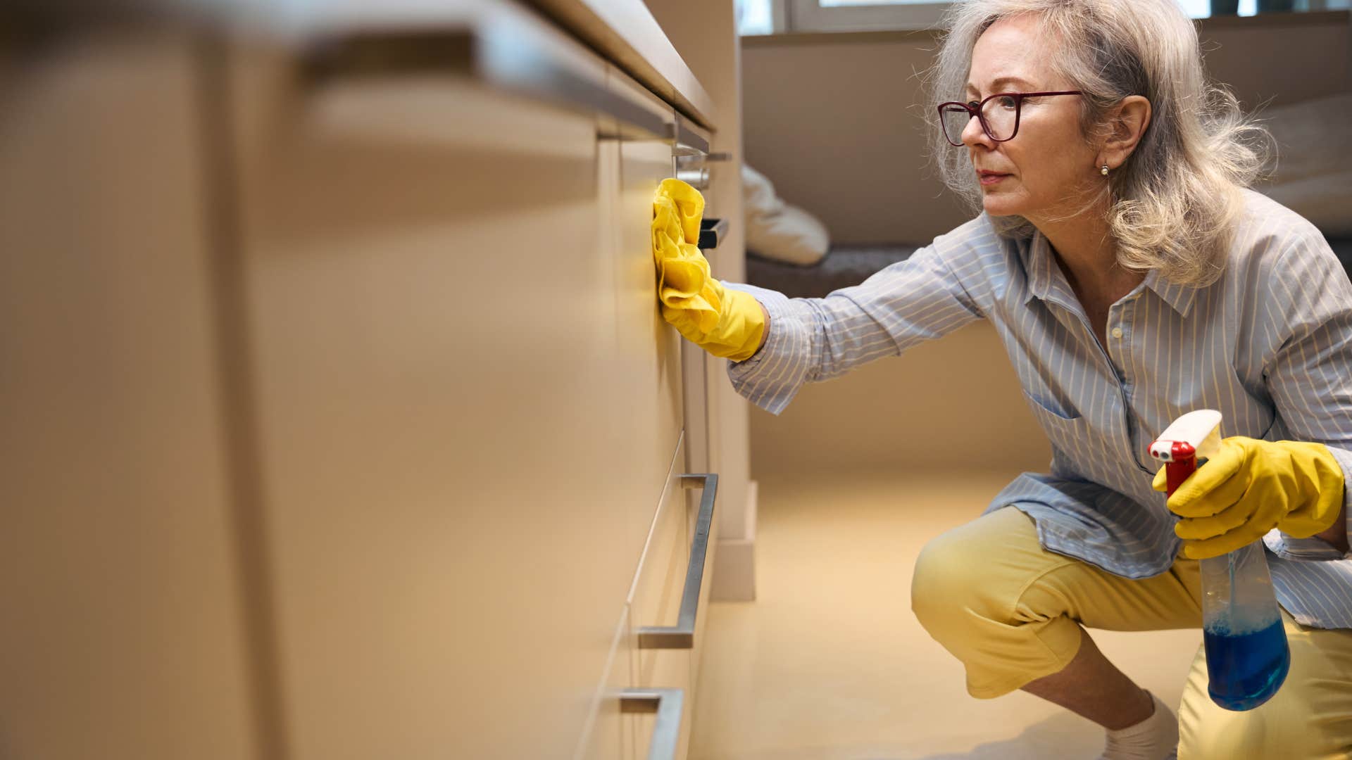 woman wiping down counters