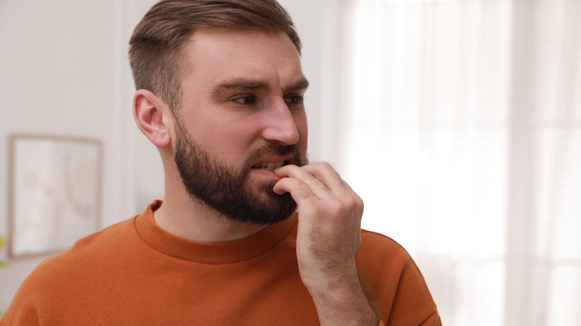 man with chewed nails looking nervous