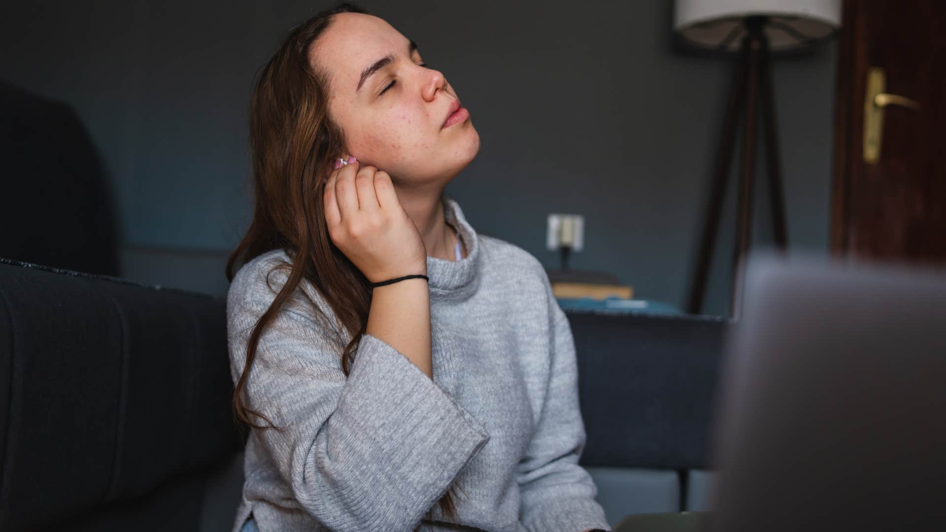 upset woman not wearing her typical clothes at home