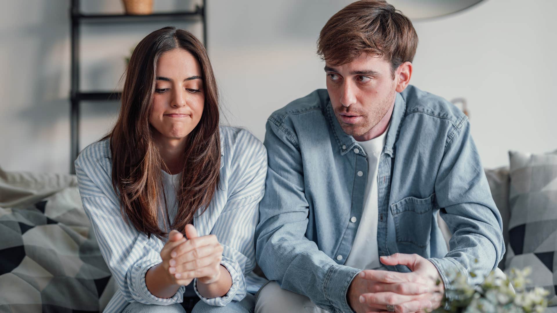 woman putting on a forced smile next to her partner