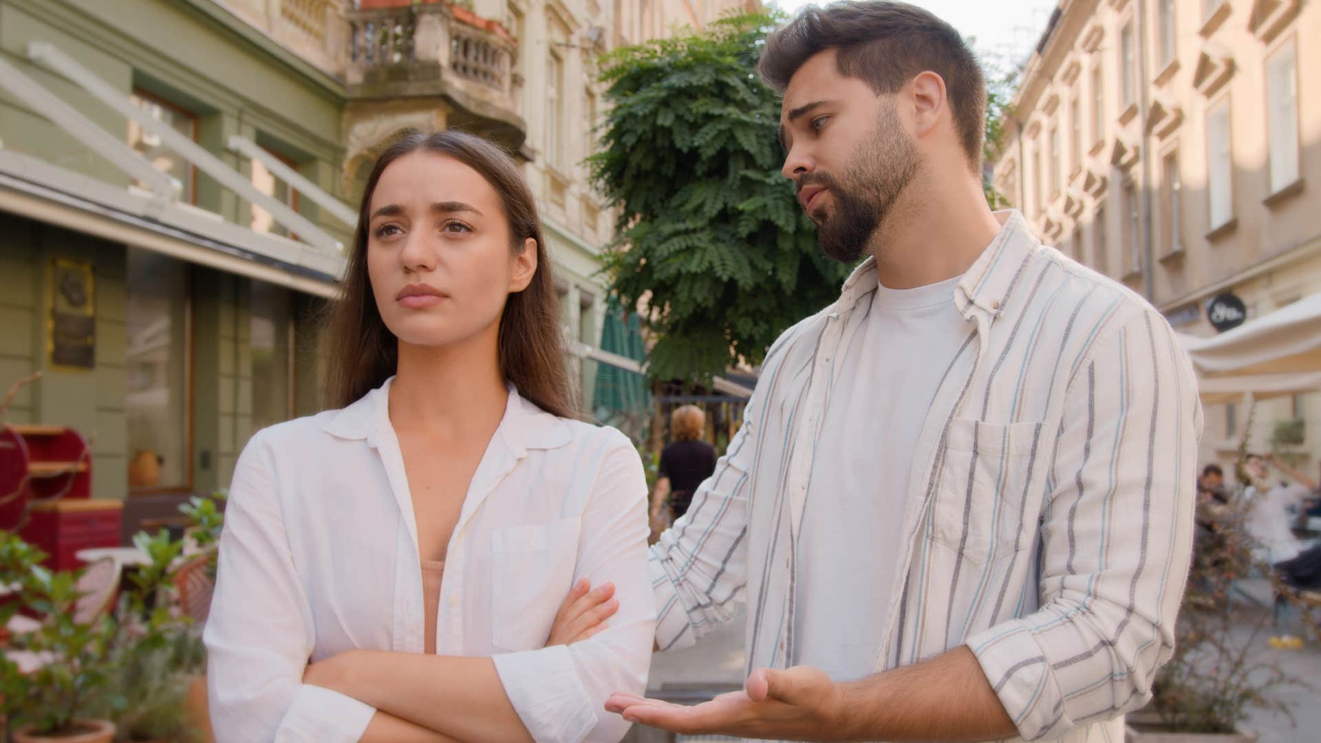 man apologizing openly to his partner in public