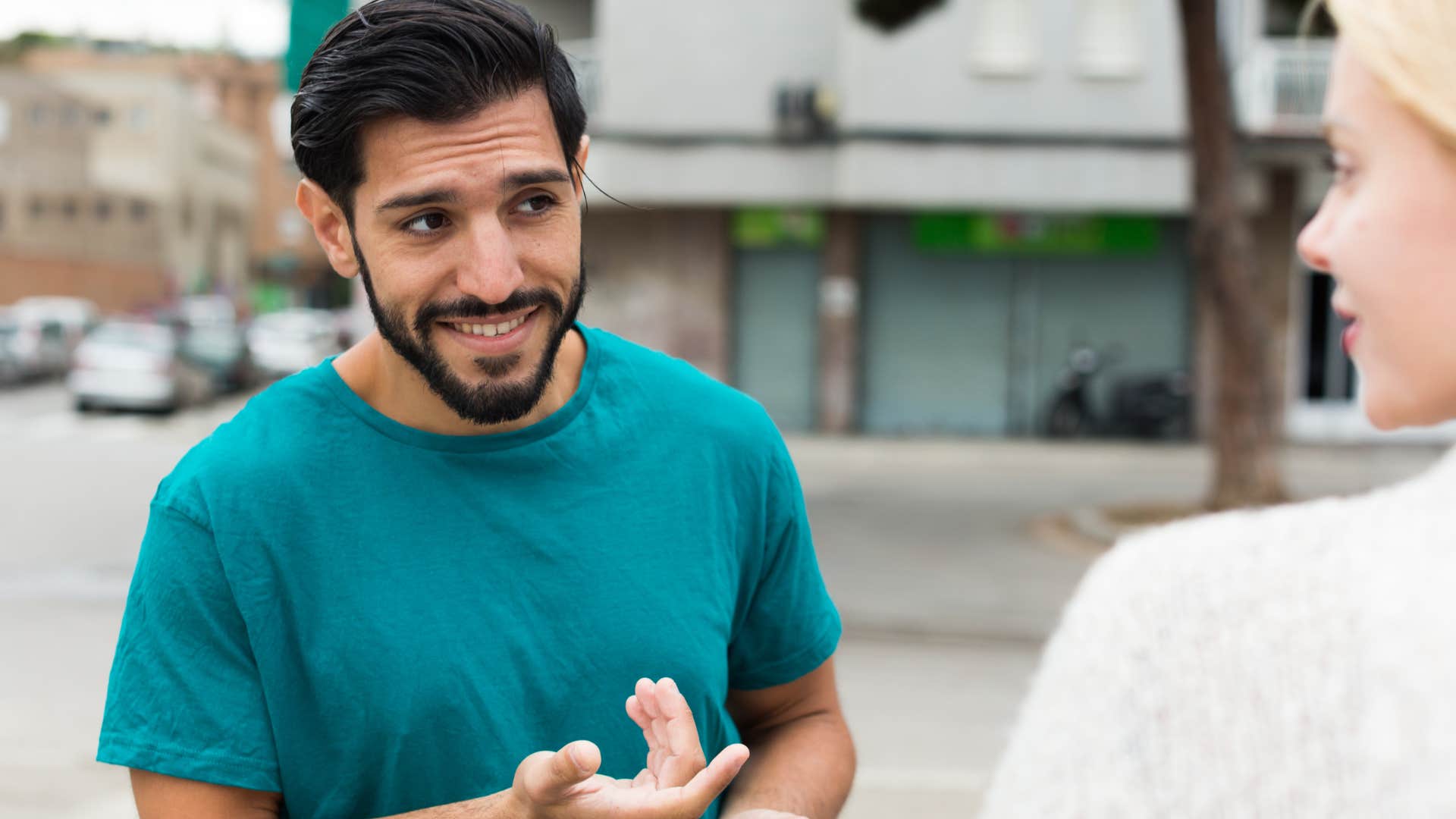 man checking in on stranger who looks upset in public