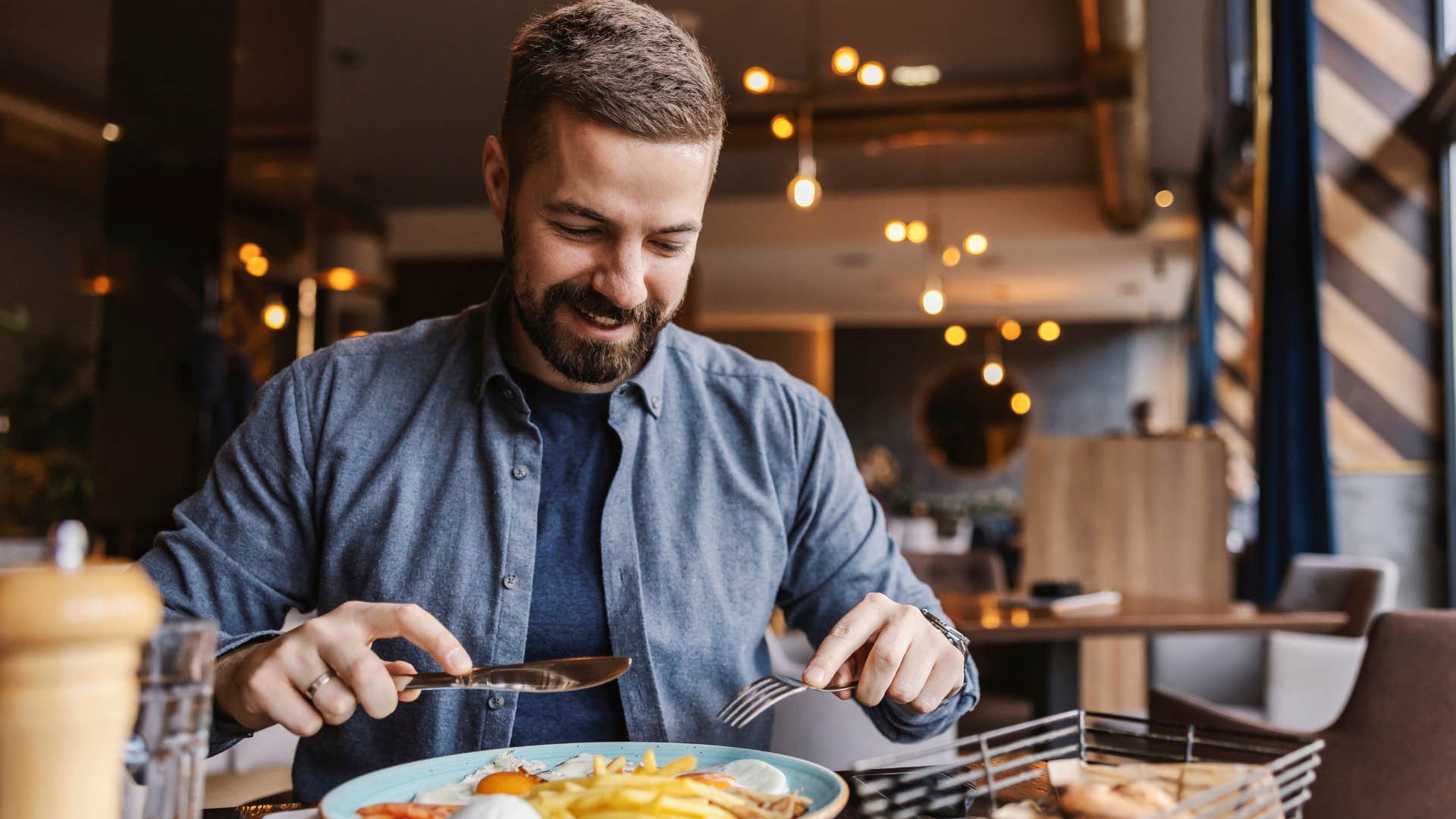 man eating breakfast in a restaurant