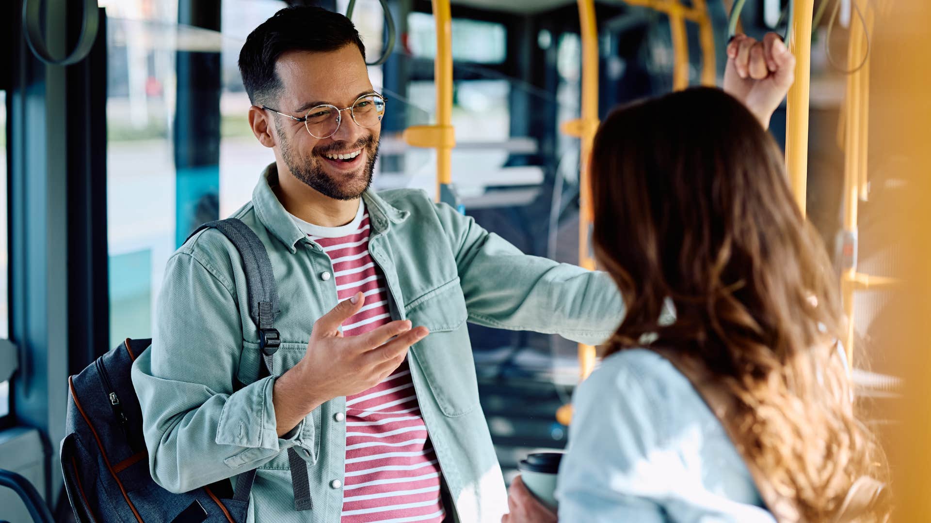 man waiting for his turn in conversation on the bus