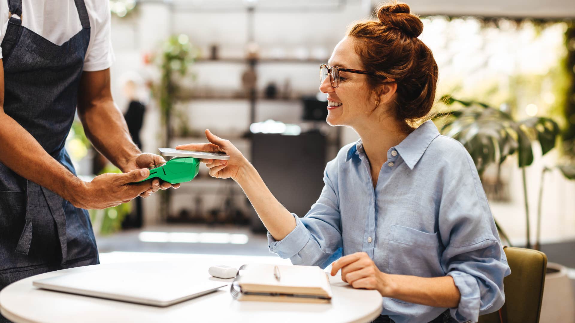woman leaving a generous tip for good service at a restaurant