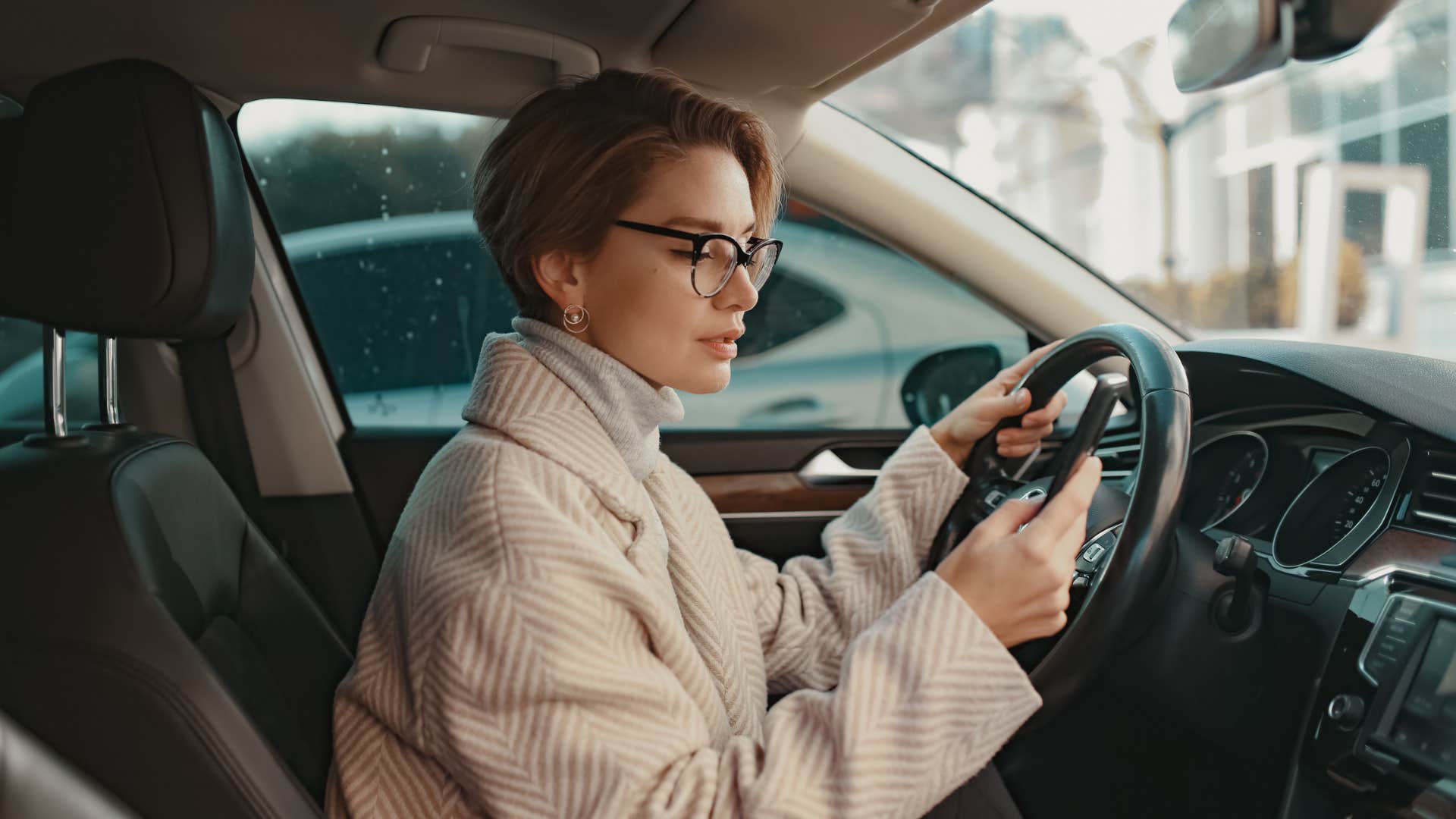 woman using her phone while in car