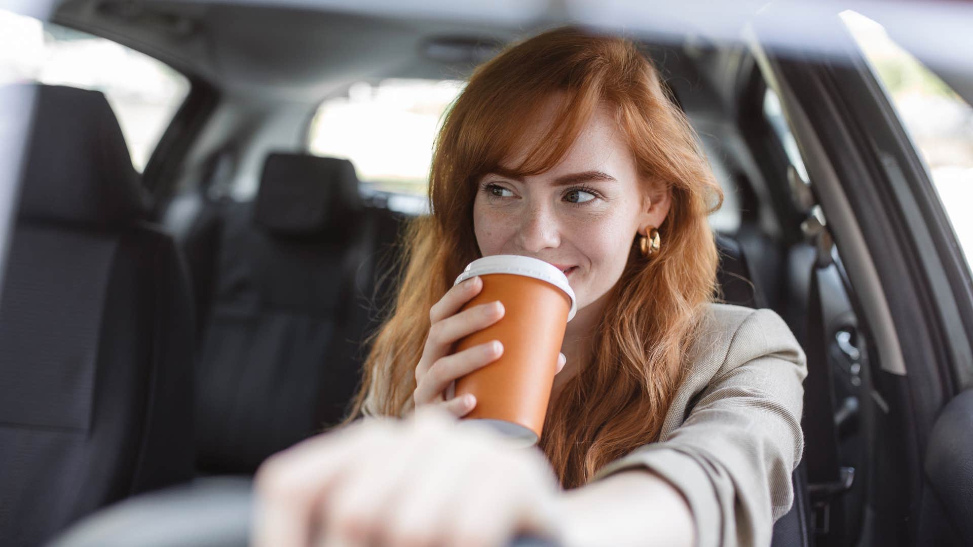 mom drinking coffee while driving
