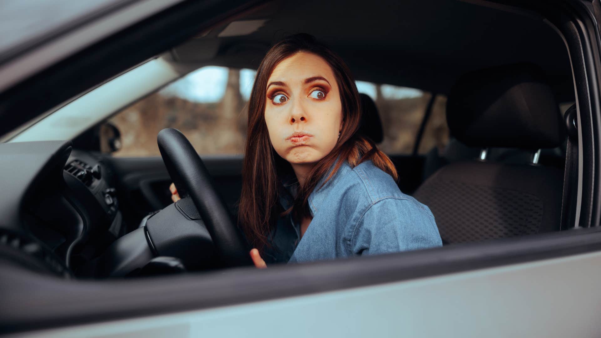 stressed woman driving with low gas tank