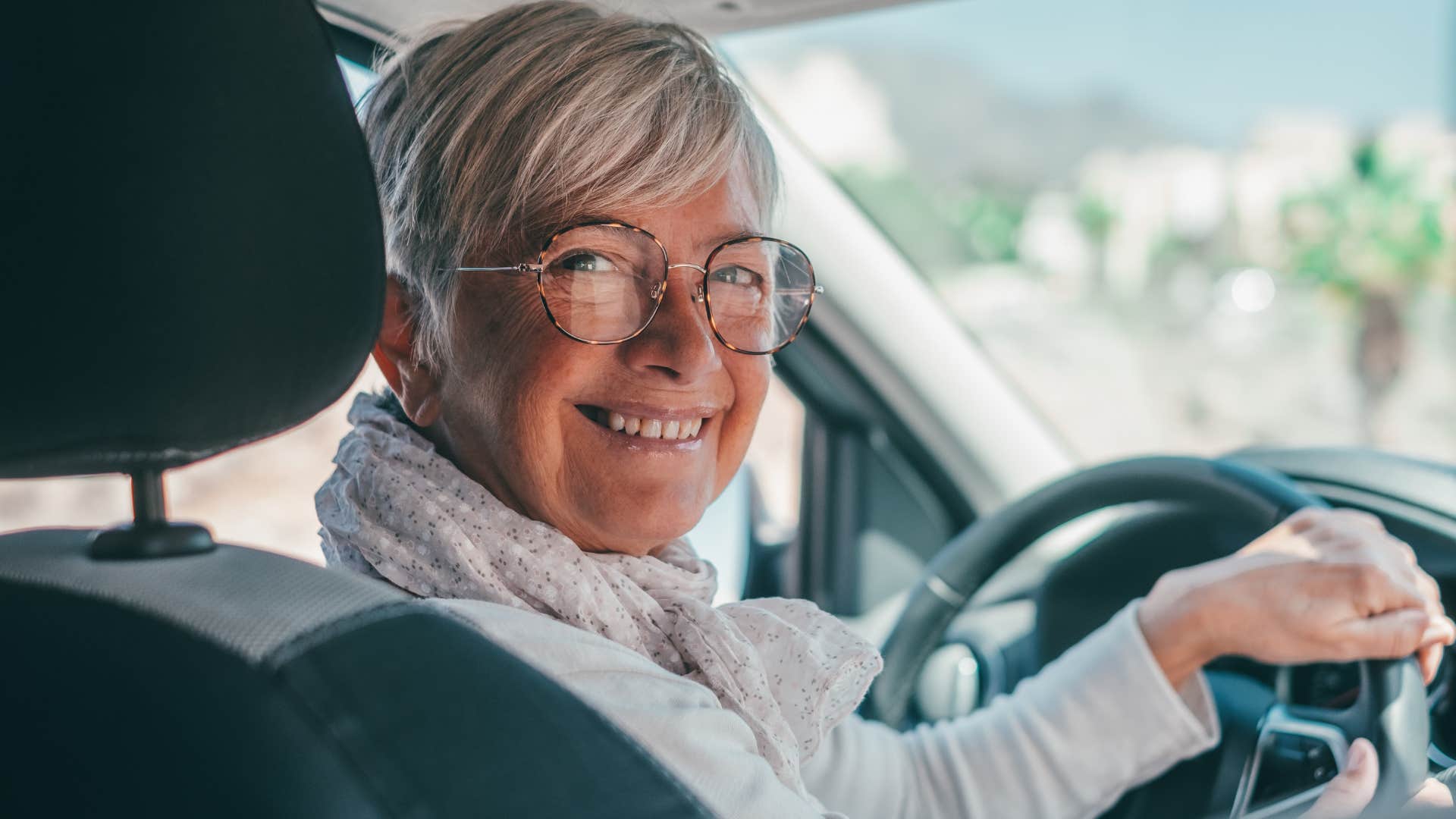 older woman listening to a calm playlist in her car