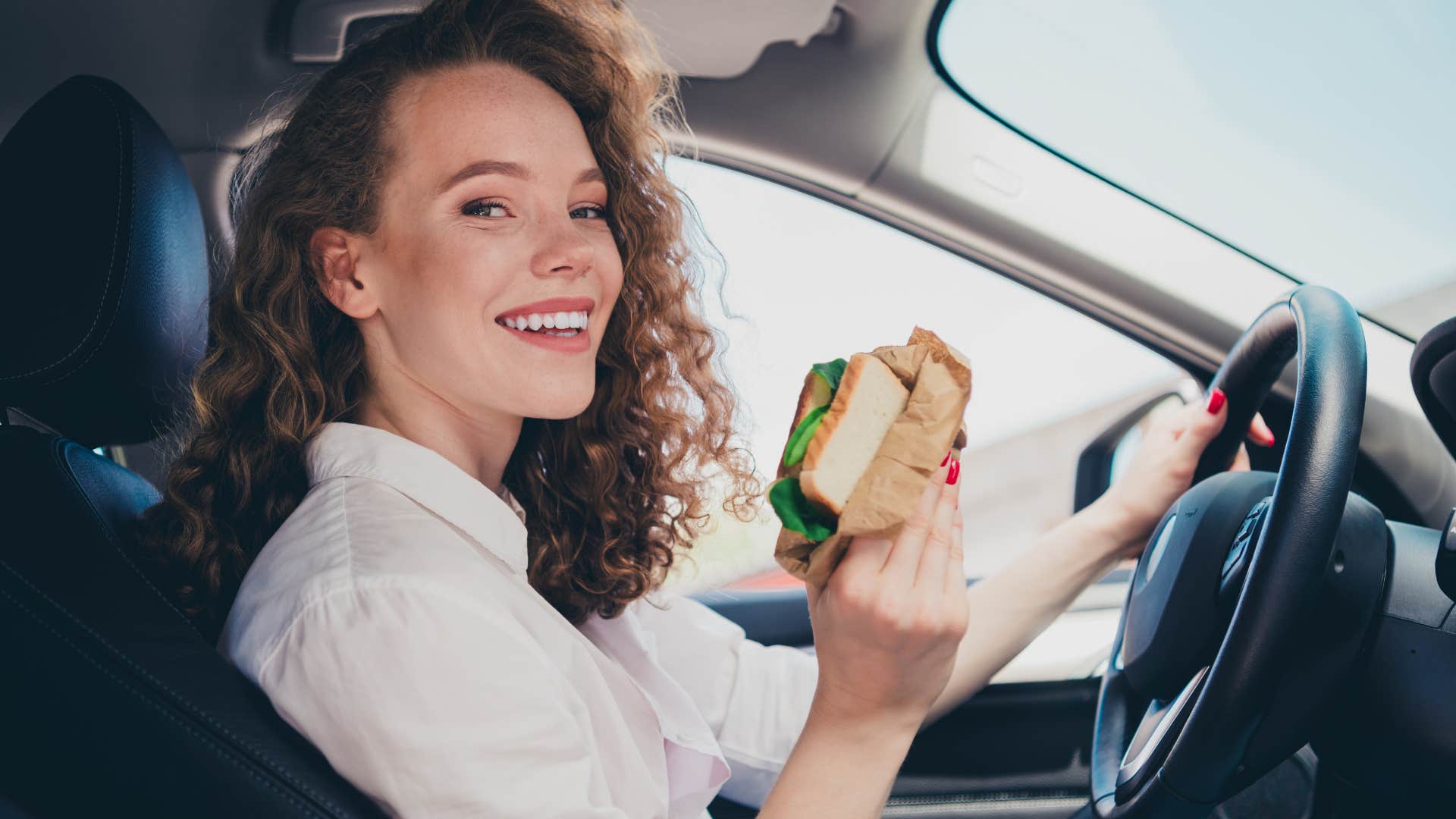 woman eating nutritional snacks in her car