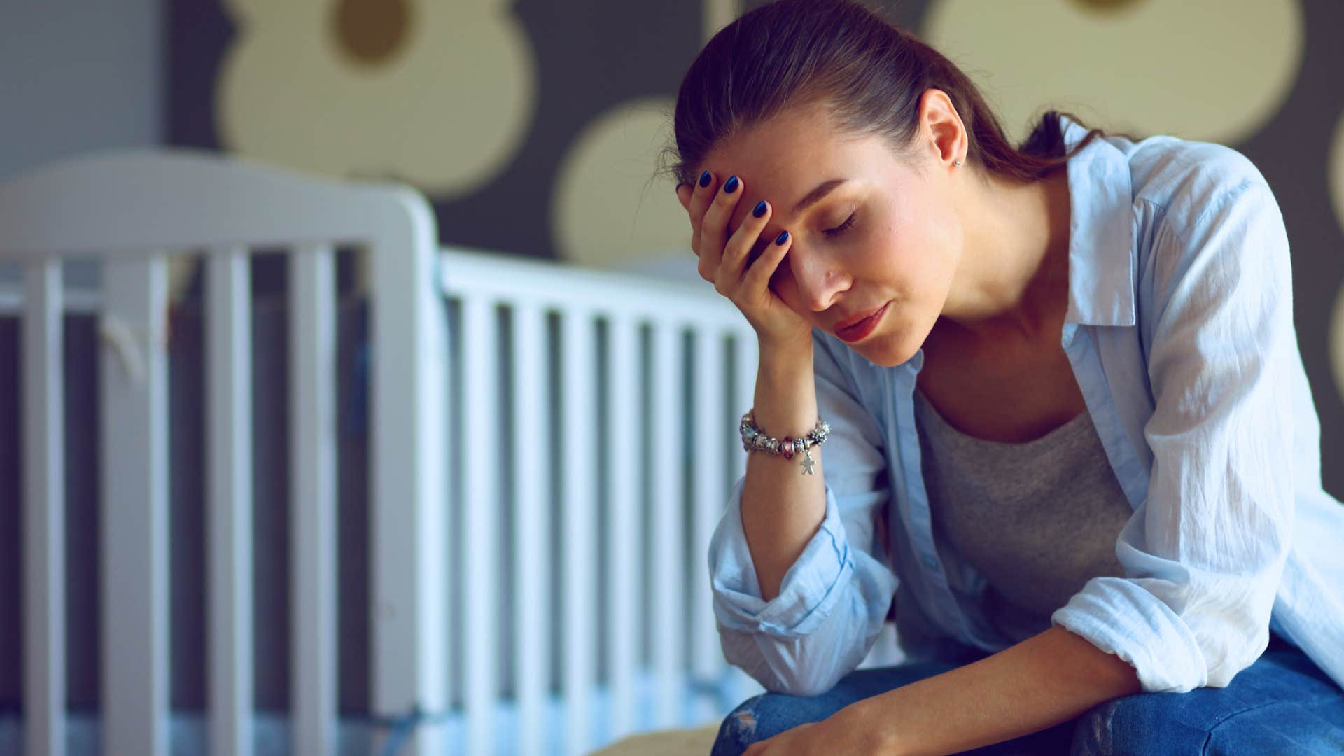 Woman looking sad around unopened crafts and board games.