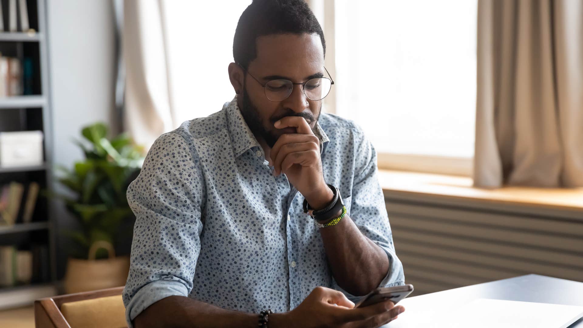 man looking at texts with someone who ghosted him