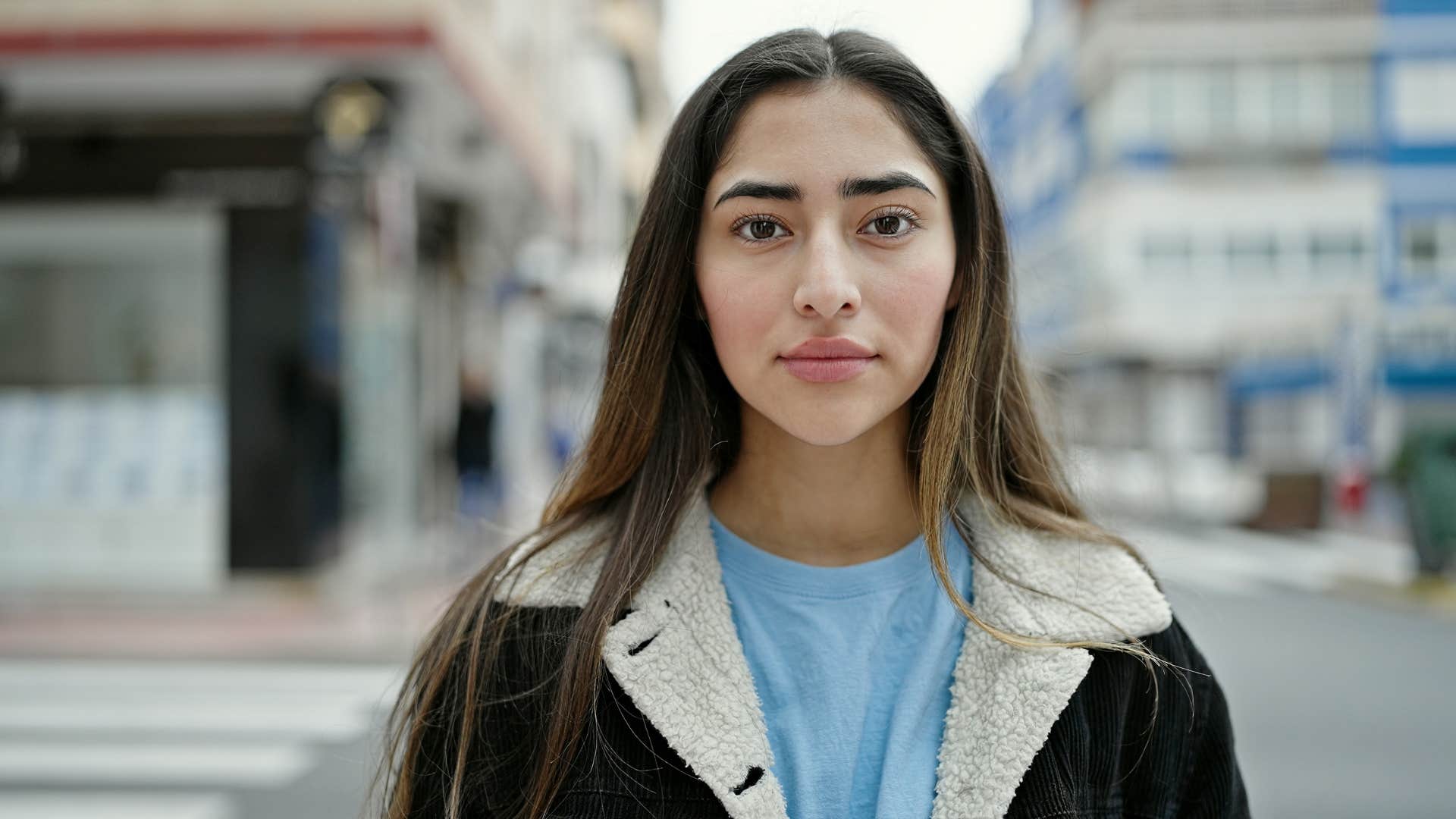 serious young woman standing outside