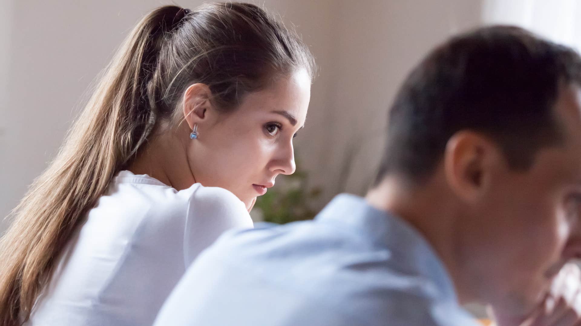 Woman looking at her husband not keeping eye contact.