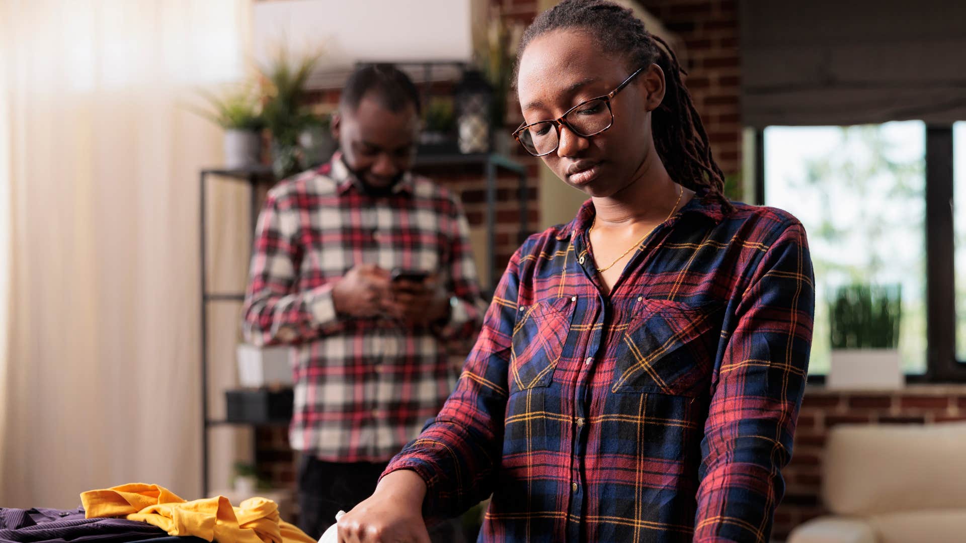 Woman turned away from her husband not noticing when you're upset.