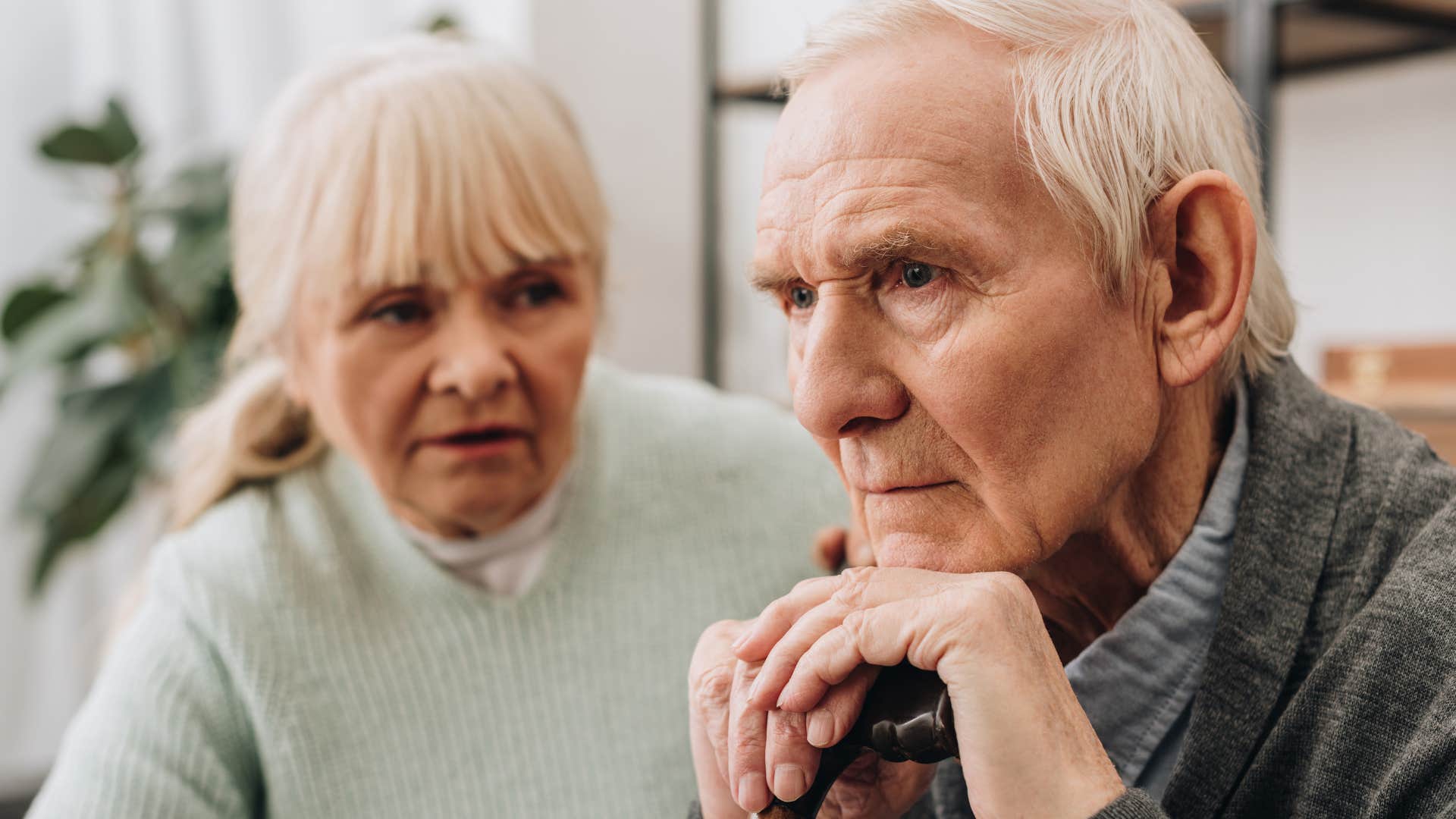 Upset man saying "I didn't mean it like that" to his wife.