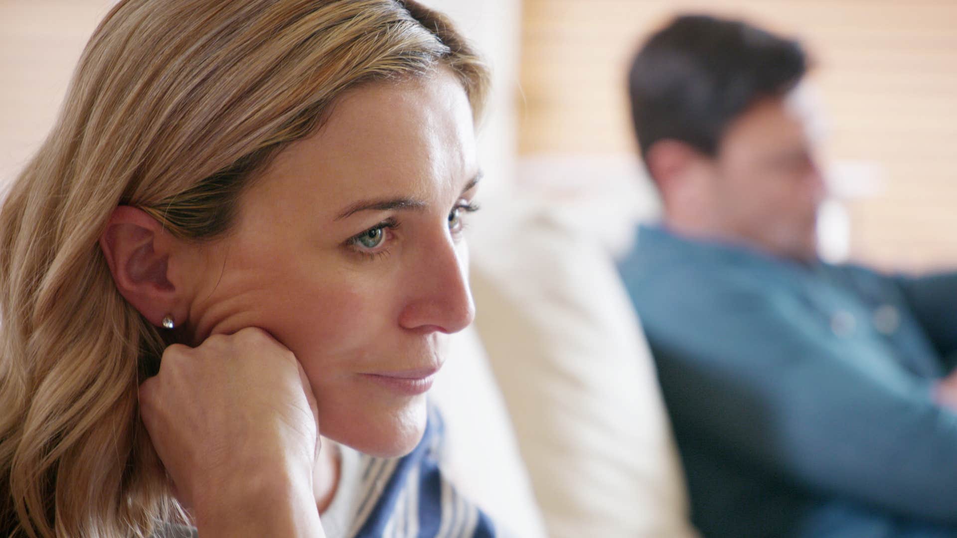 Woman turned away from her husband saying "I'm not talking about that."