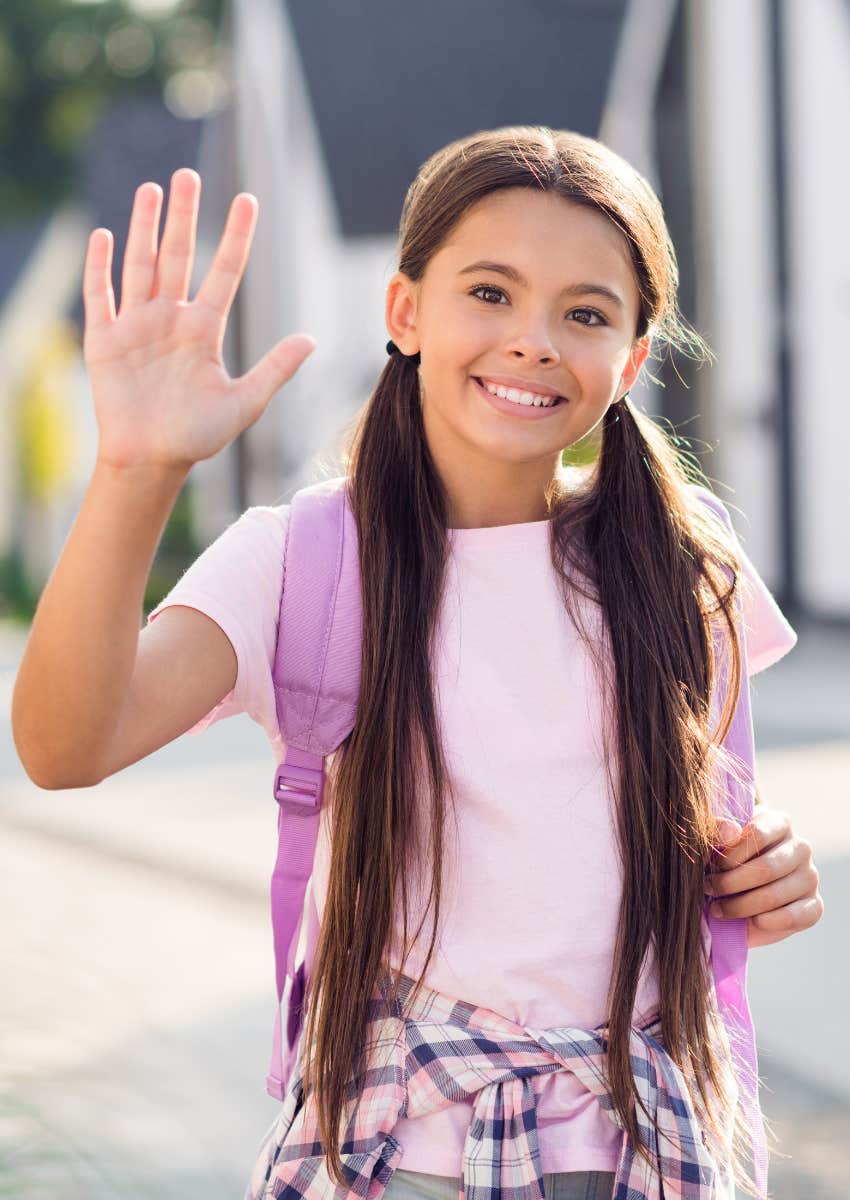 girl waving goodbye
