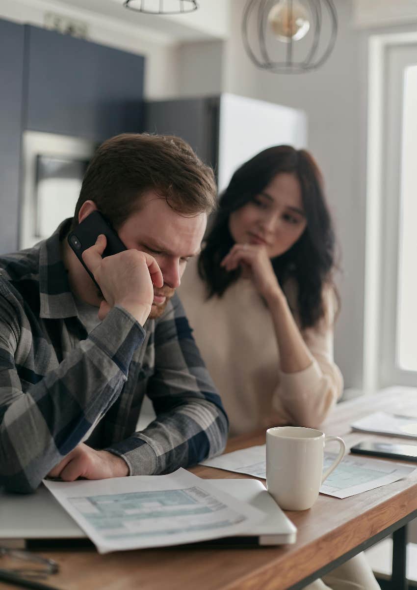 man on the phone paying bills