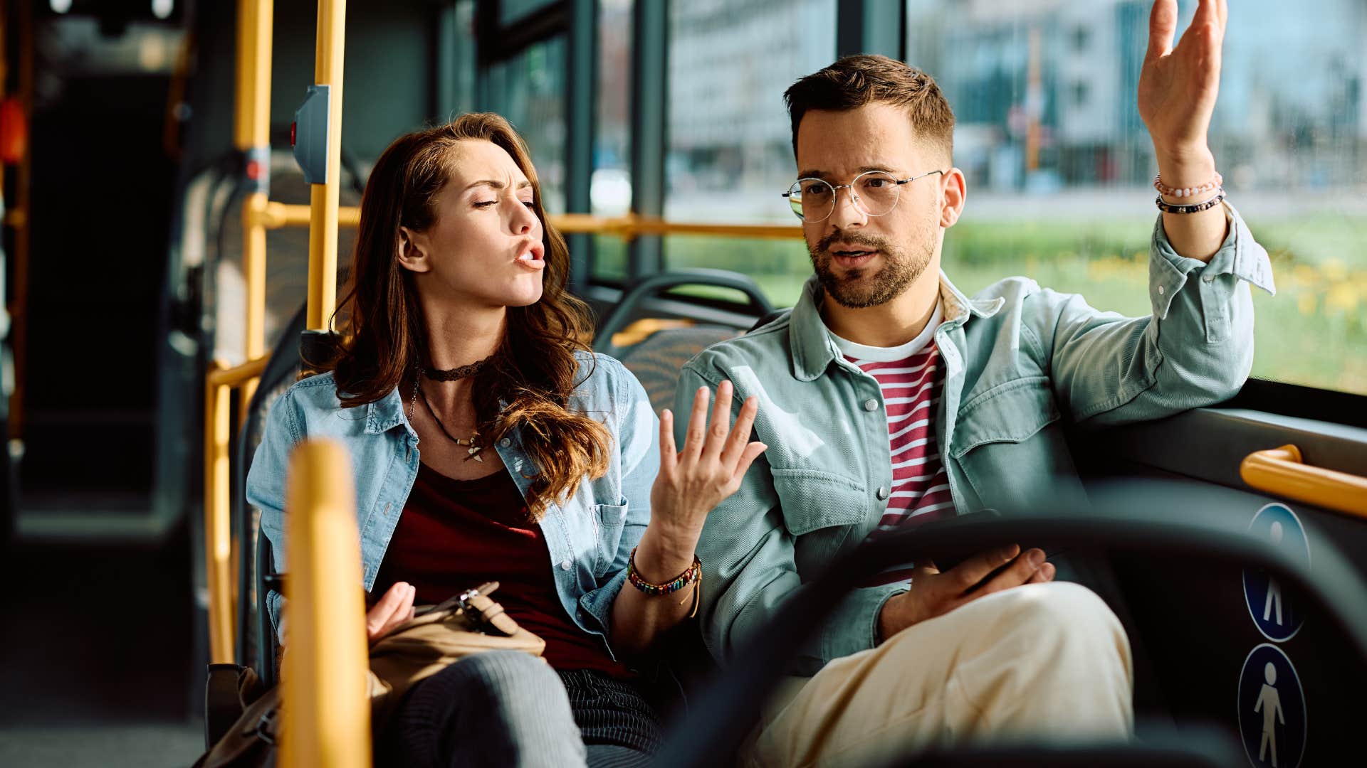 couple escalating small issues arguing on bus