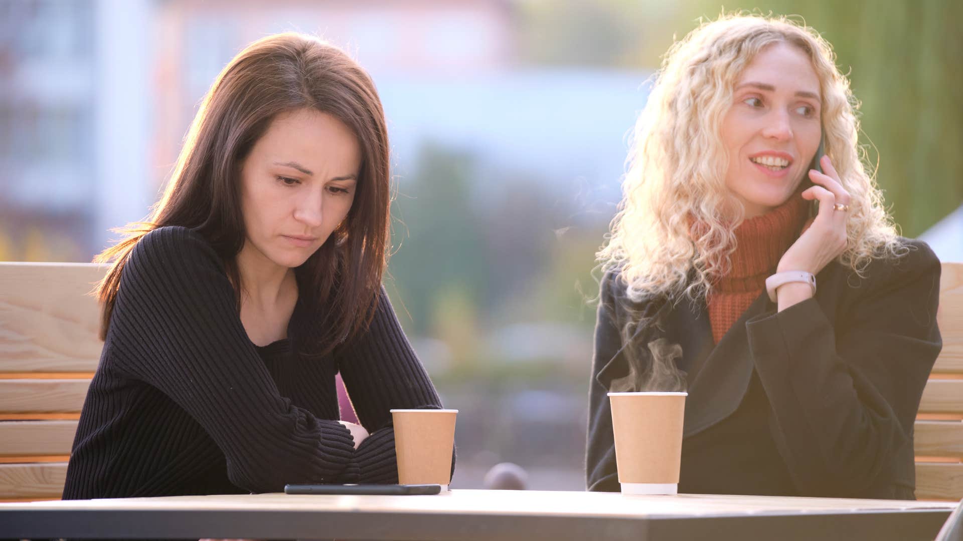 woman on phone who lacks listening skills ignoring friend