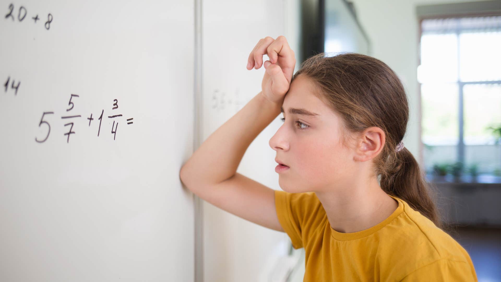 young girl using butterfly method to solve math problems