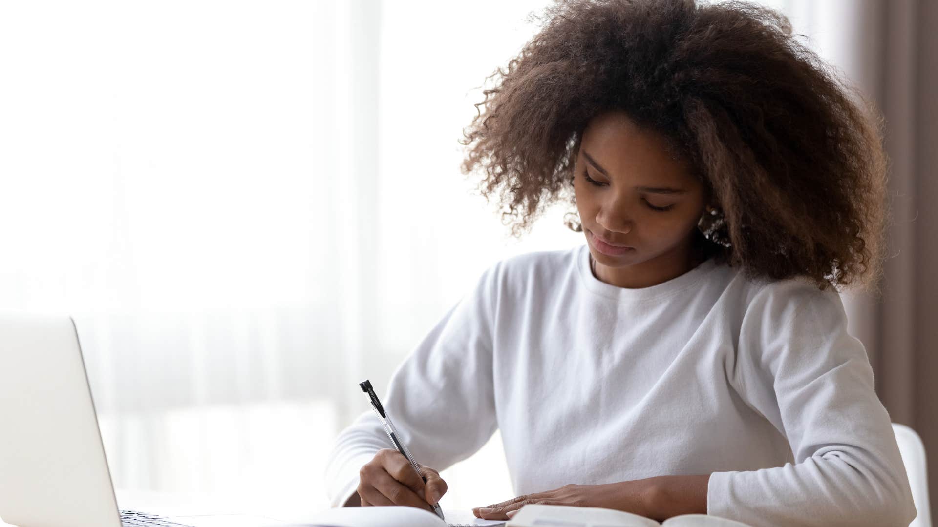 female student writing in school