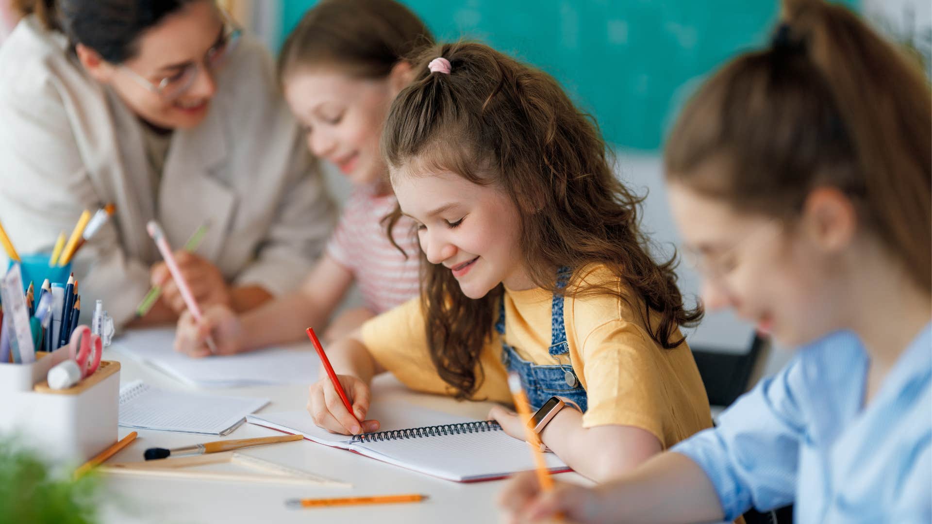 kids writing in their notebooks in class