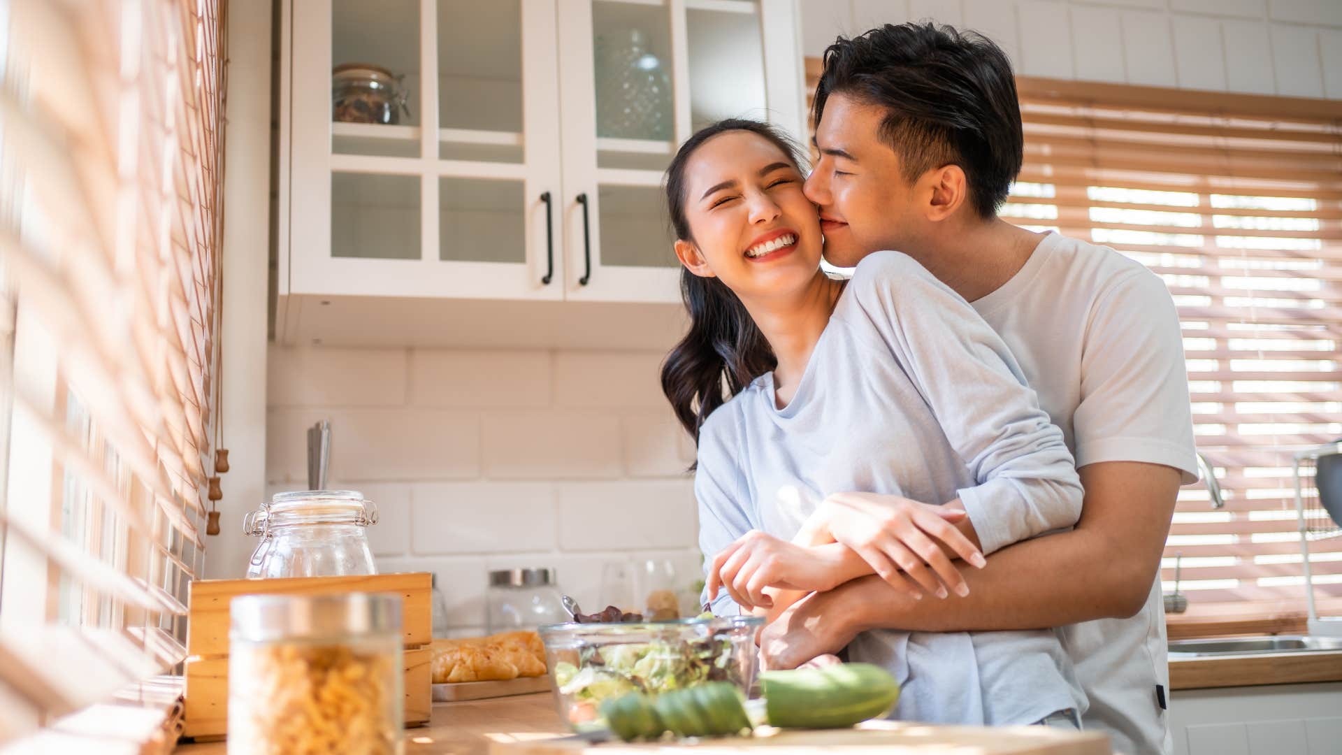 happy couple in the kitchen making each other a priority