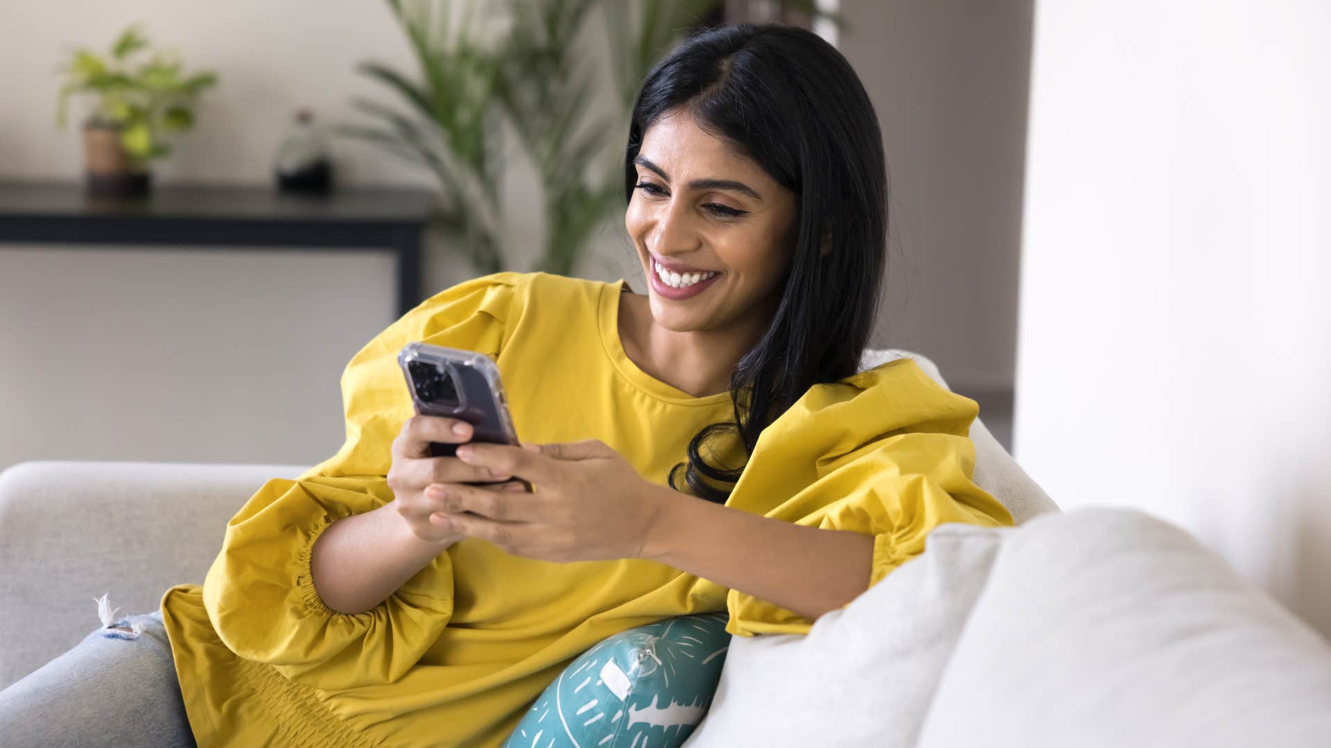 woman looking at the organized home screen on her phone