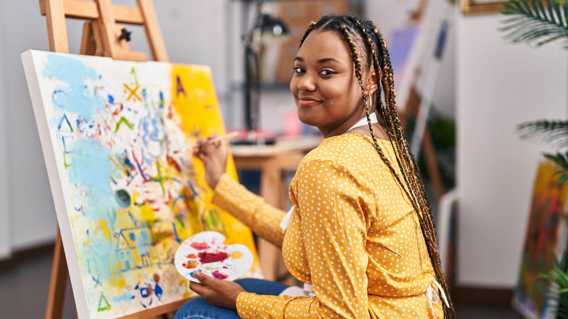 happy woman painting reconnecting with her creativity