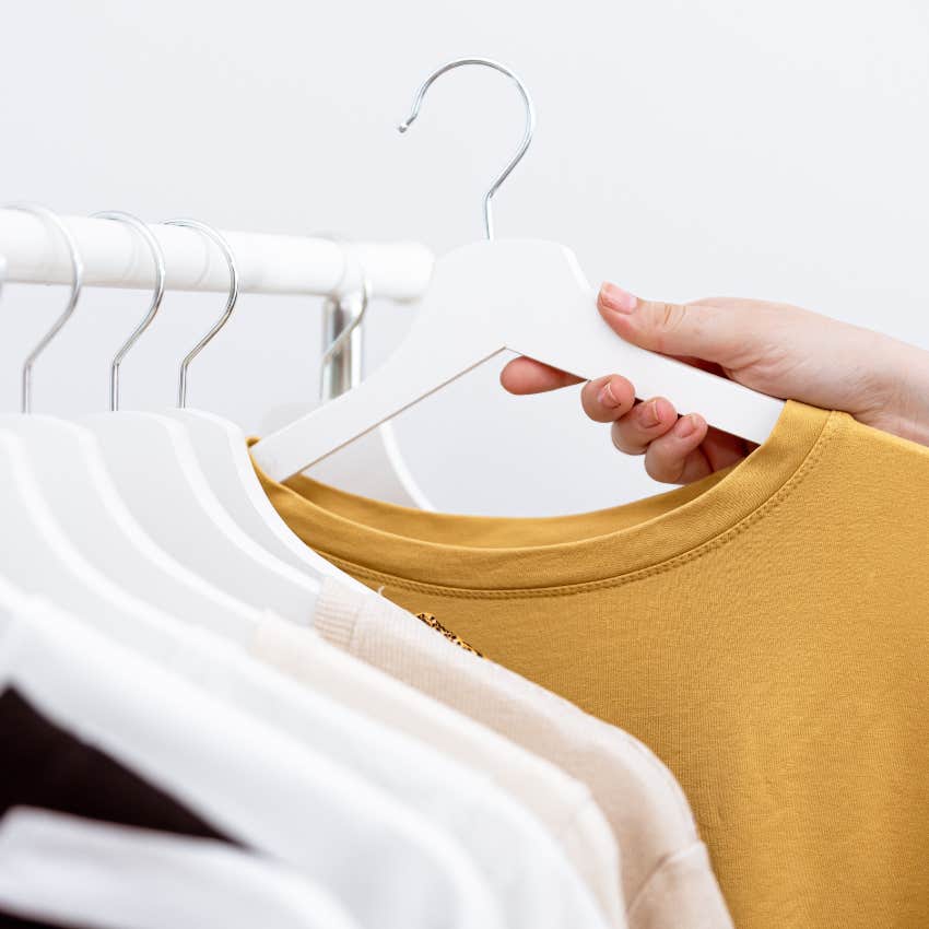 person with a meticulous house as they organize with slim hangers