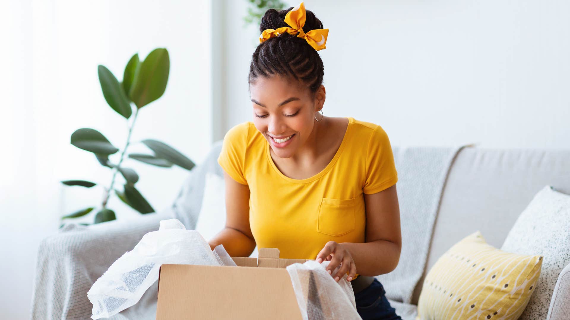 woman opening and looking in cardboard box