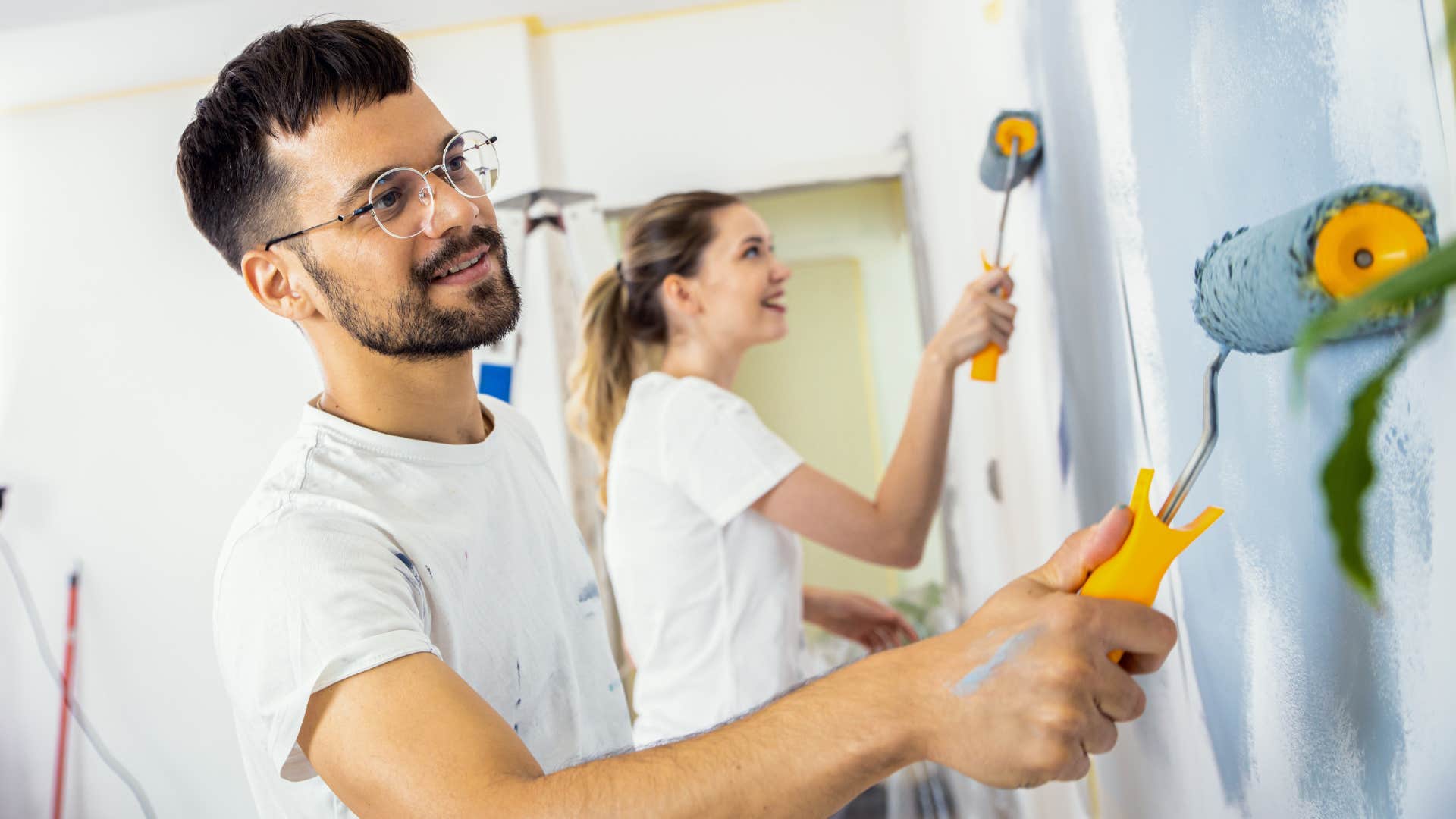 couple painting their walls at home