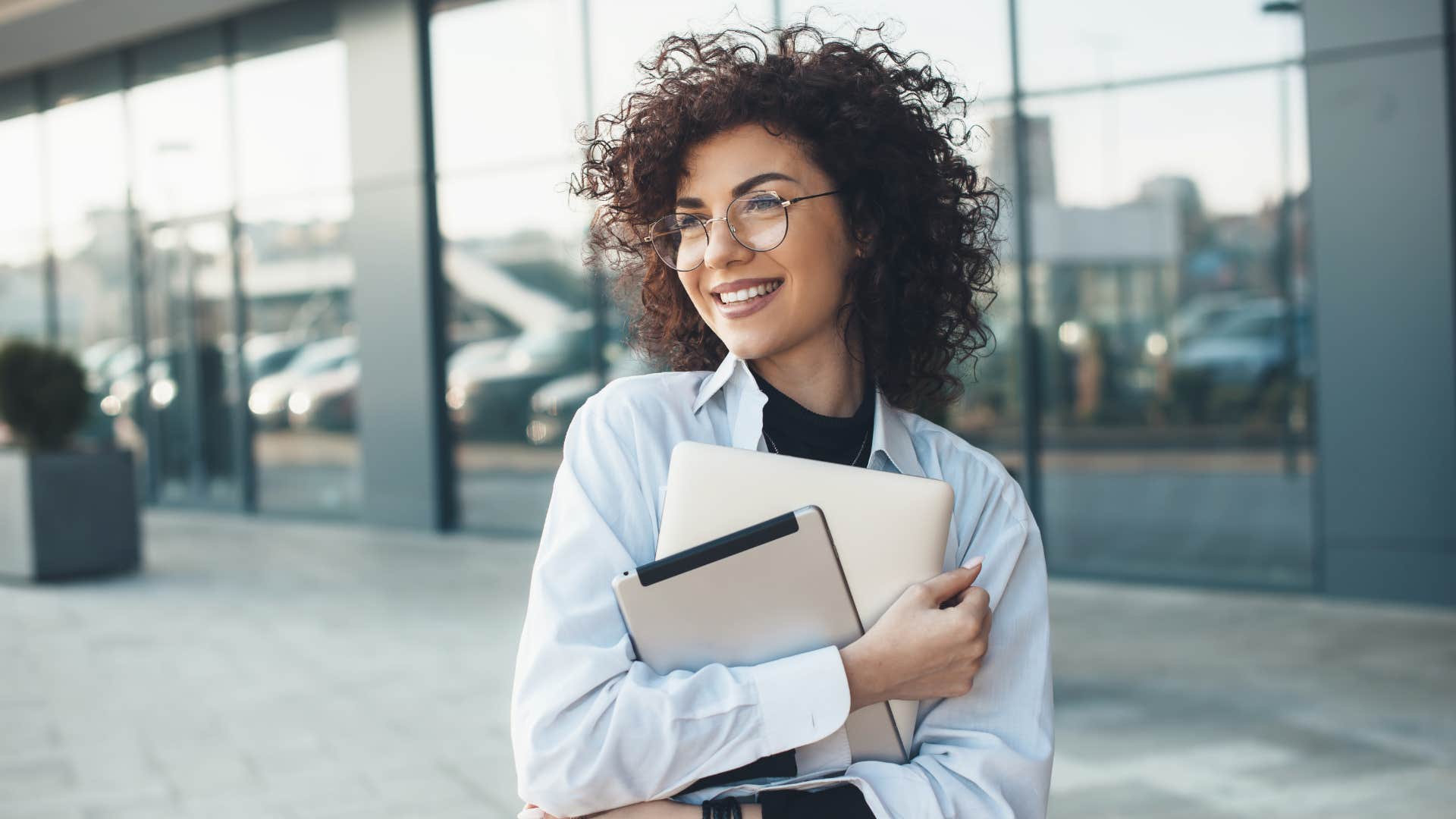 woman holding notebook outside