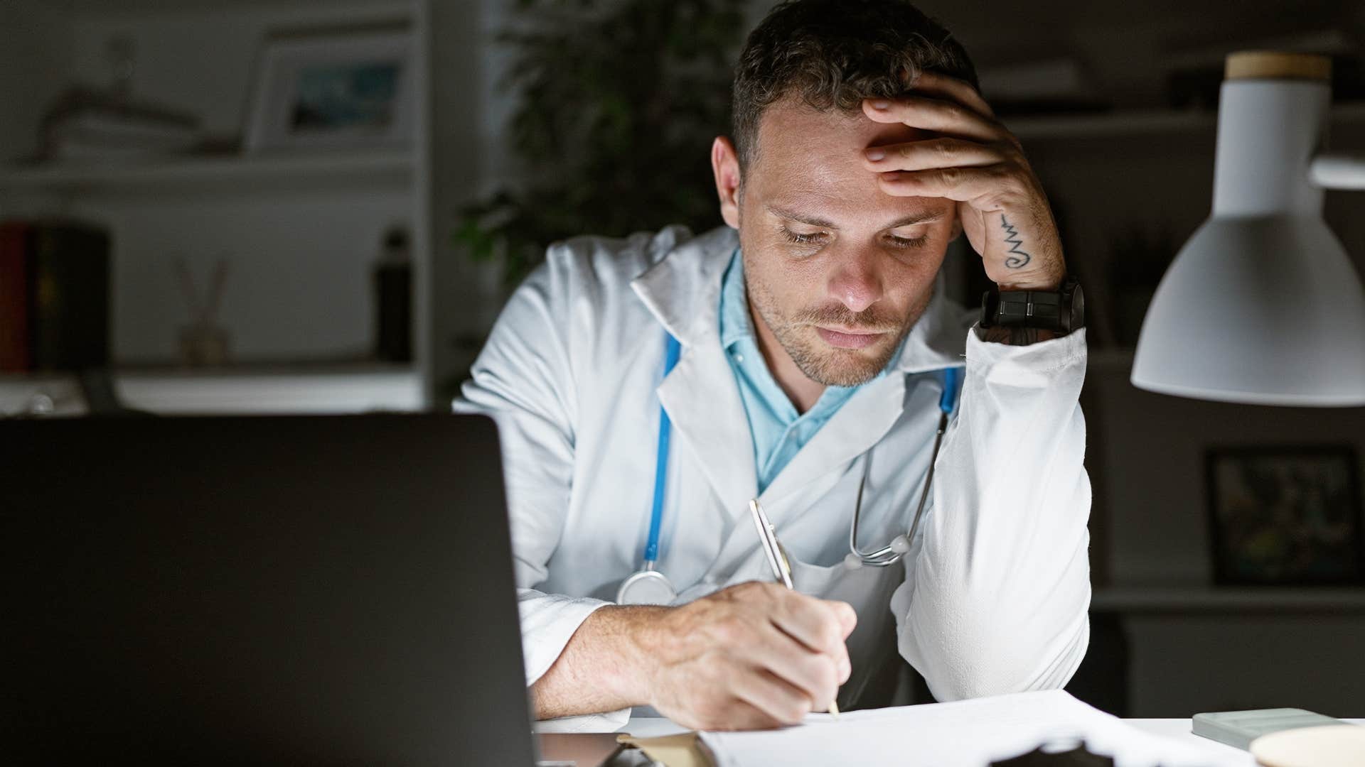 man with perfectionist tendencies working late