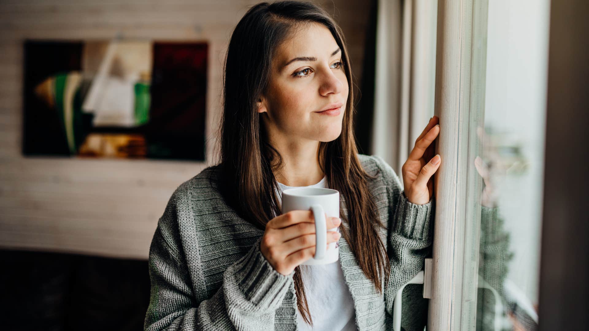woman preferring solitude looking out a window