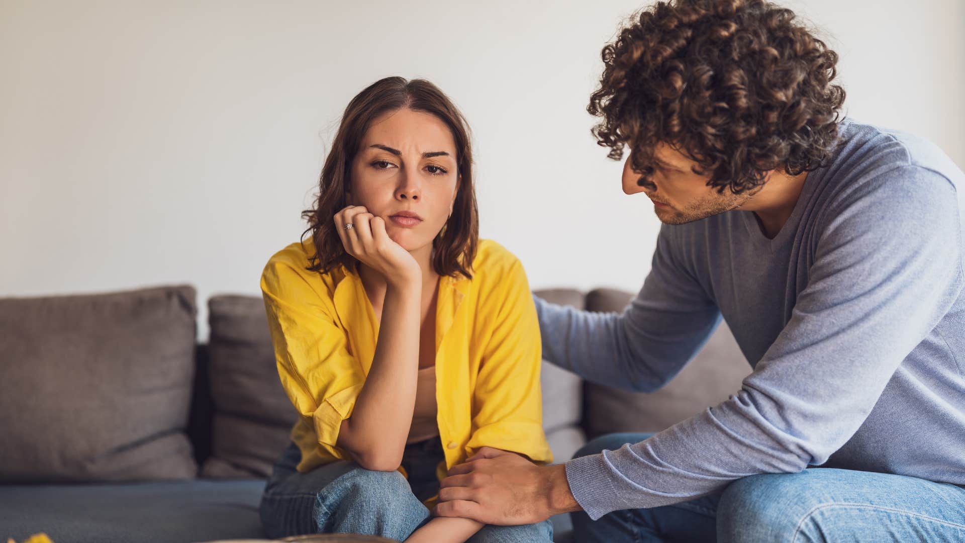 man telling woman in yellow it's the least you could do