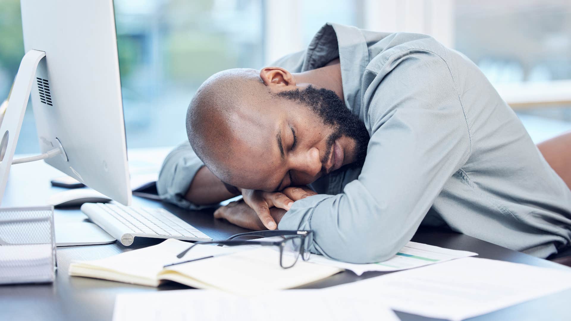 stressed worker about to quit his job falling asleep
